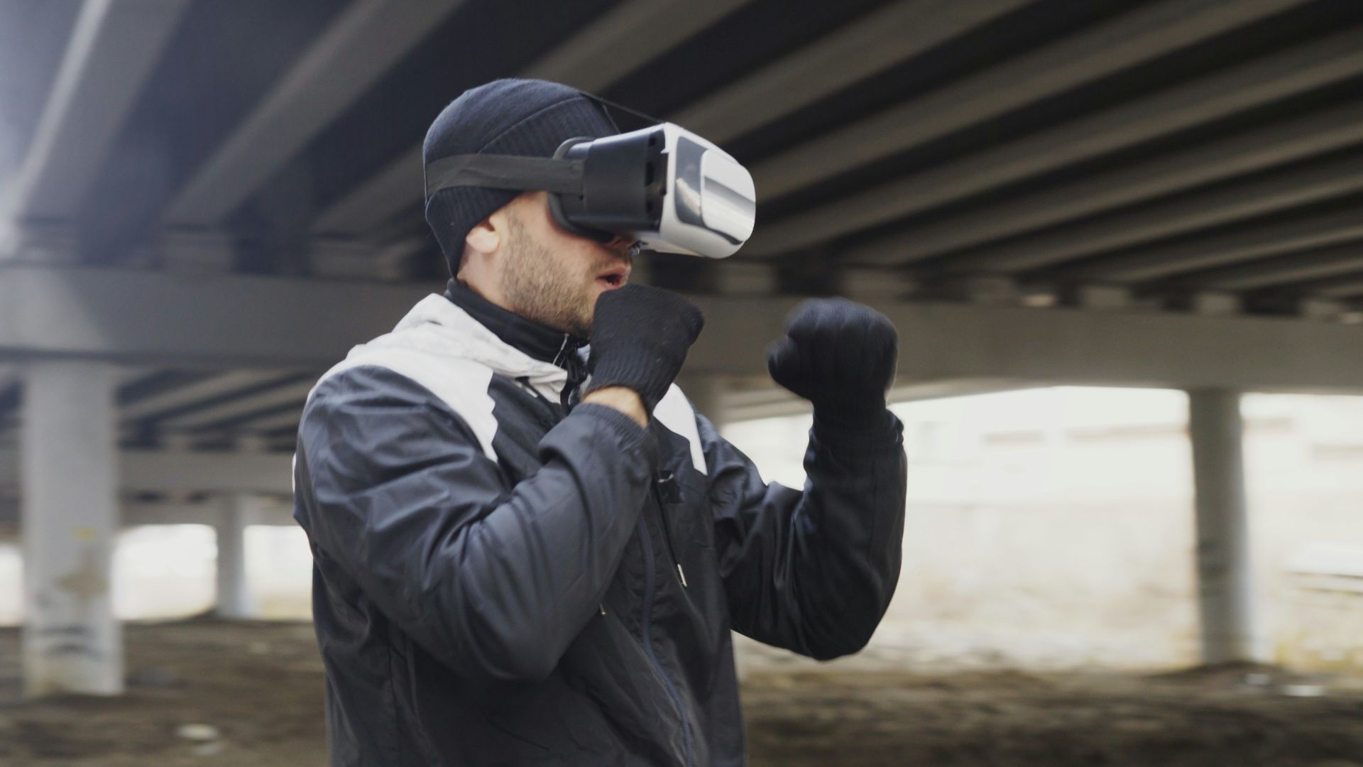 Man wearing vr headset boxing under bridge