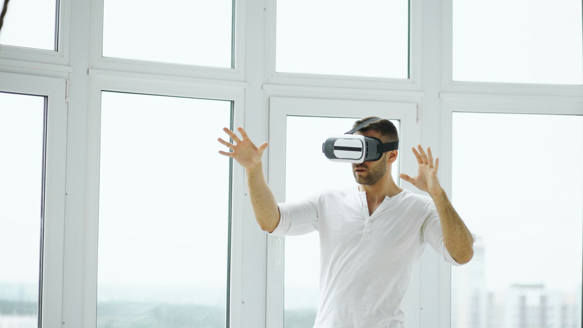 Man wearing vr headset with hands outstretched.