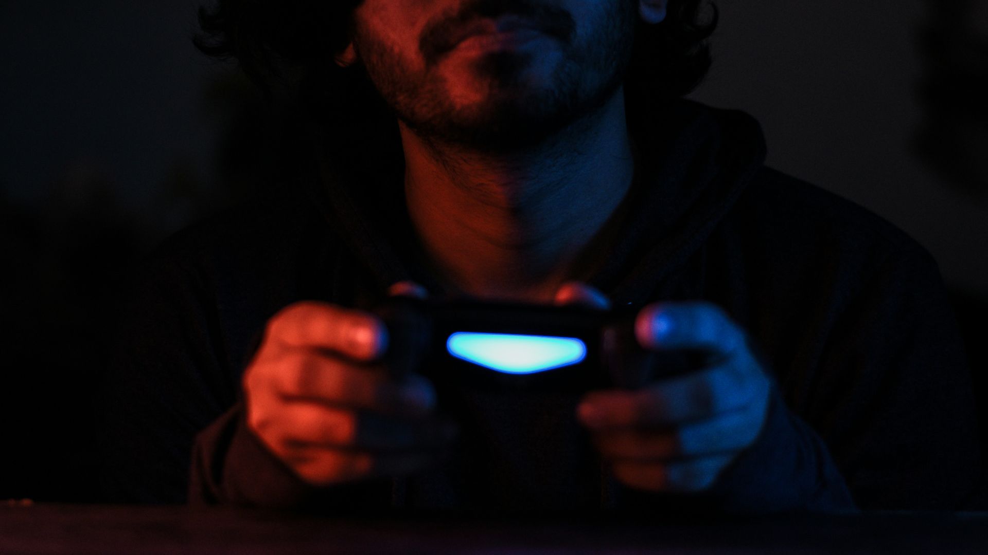 man in black jacket holding black smartphone