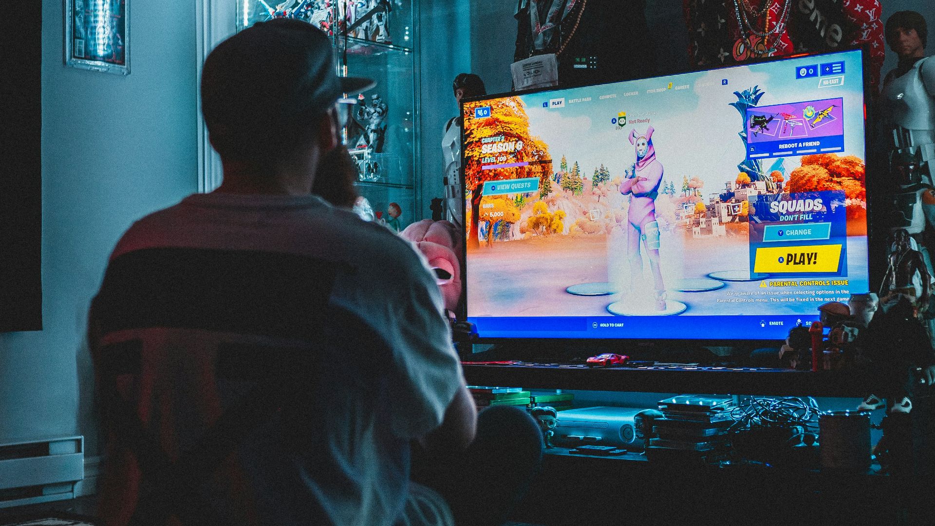 man in red shirt watching tv