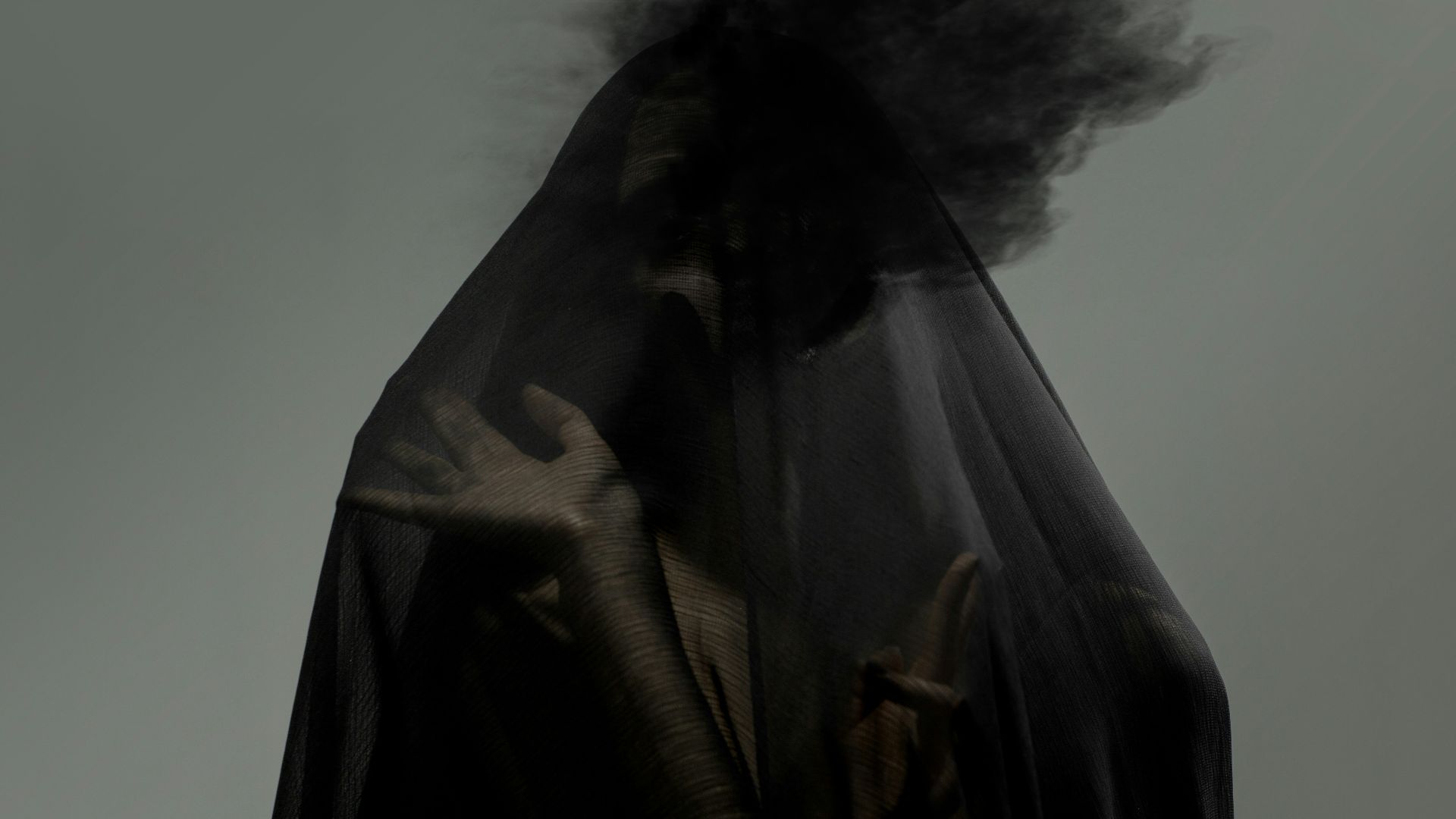 a man with a black cloak