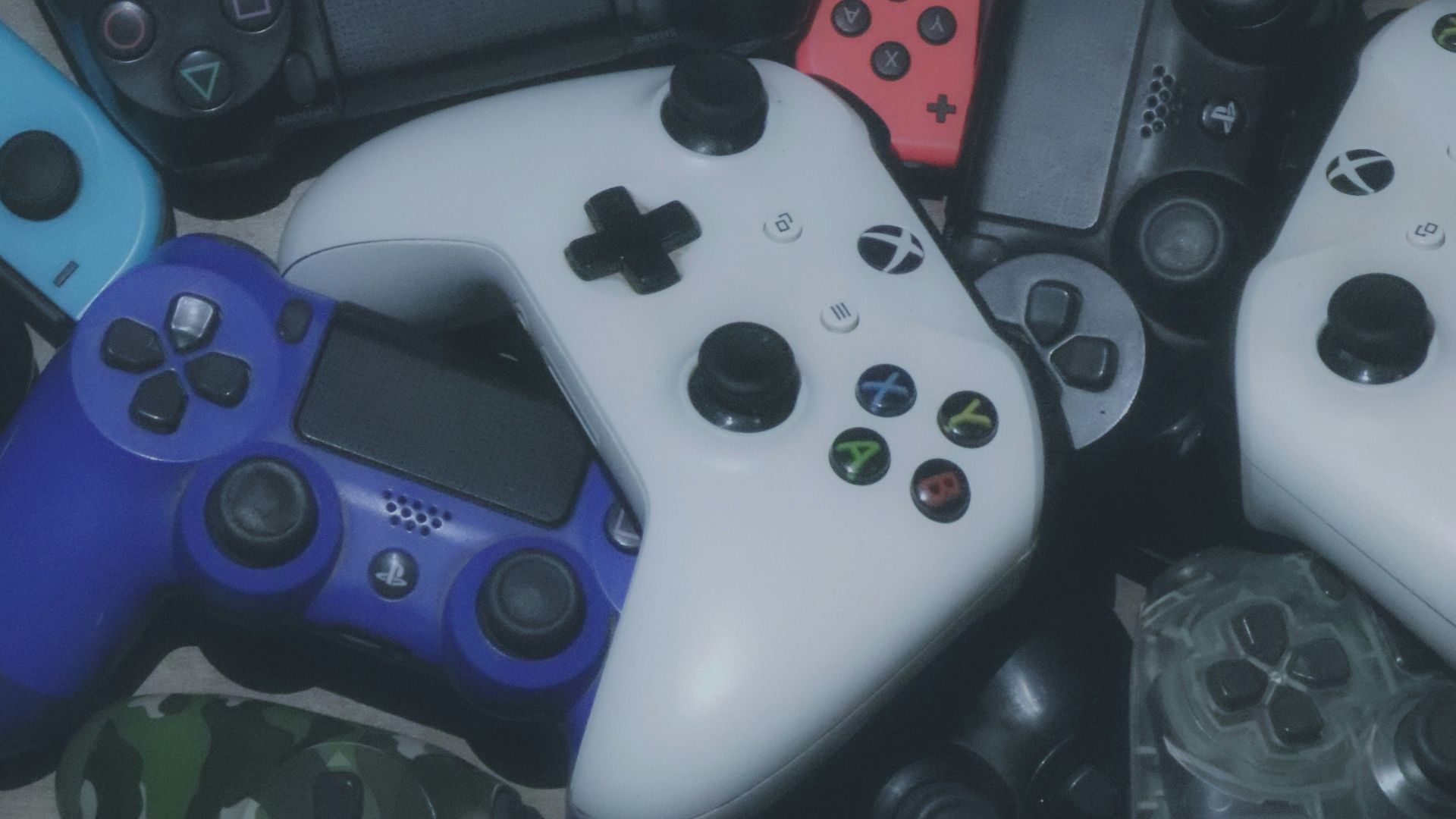 assorted-colored Xbox and Sony Playstaion game controller lot