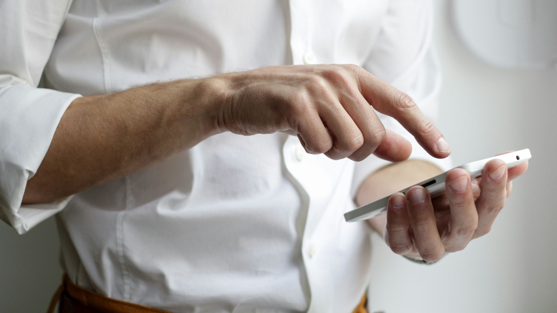 person holding white Android smartphone in white shirt