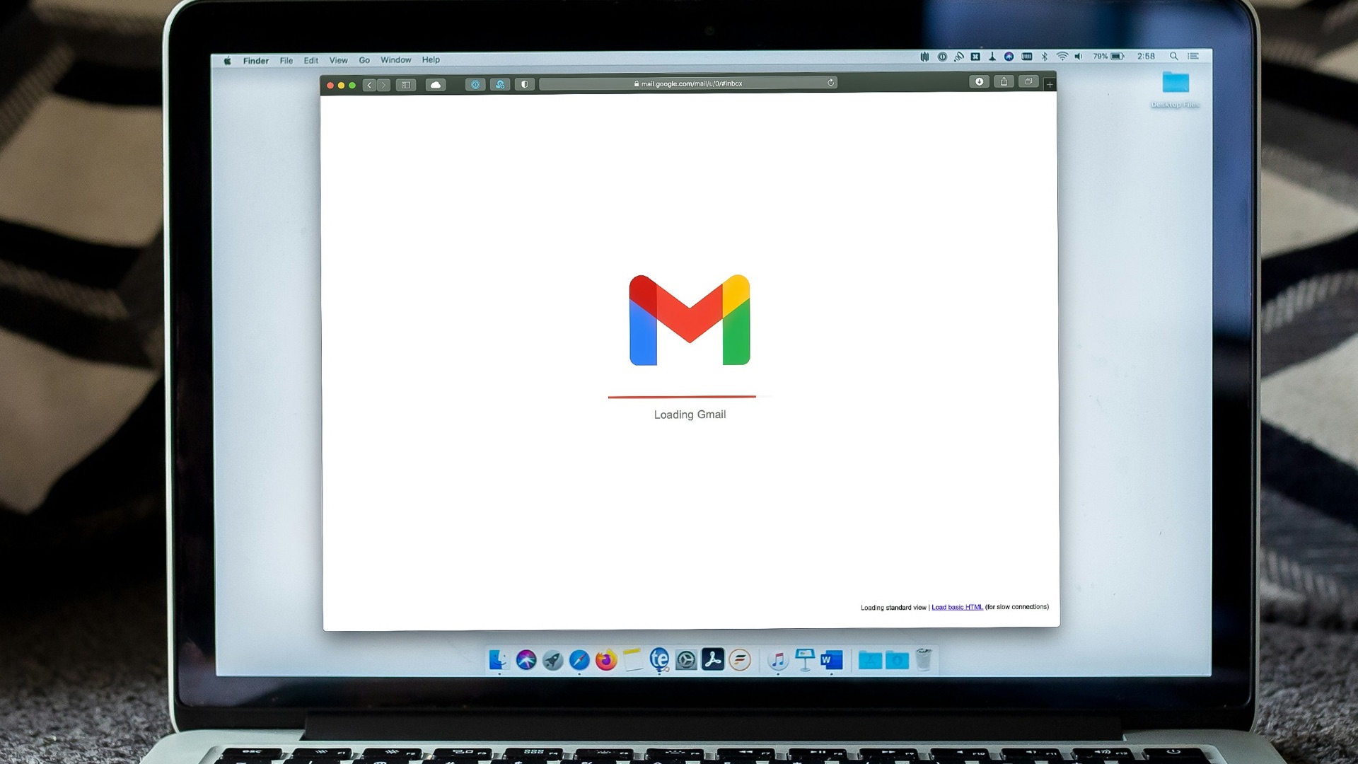 macbook pro on black textile