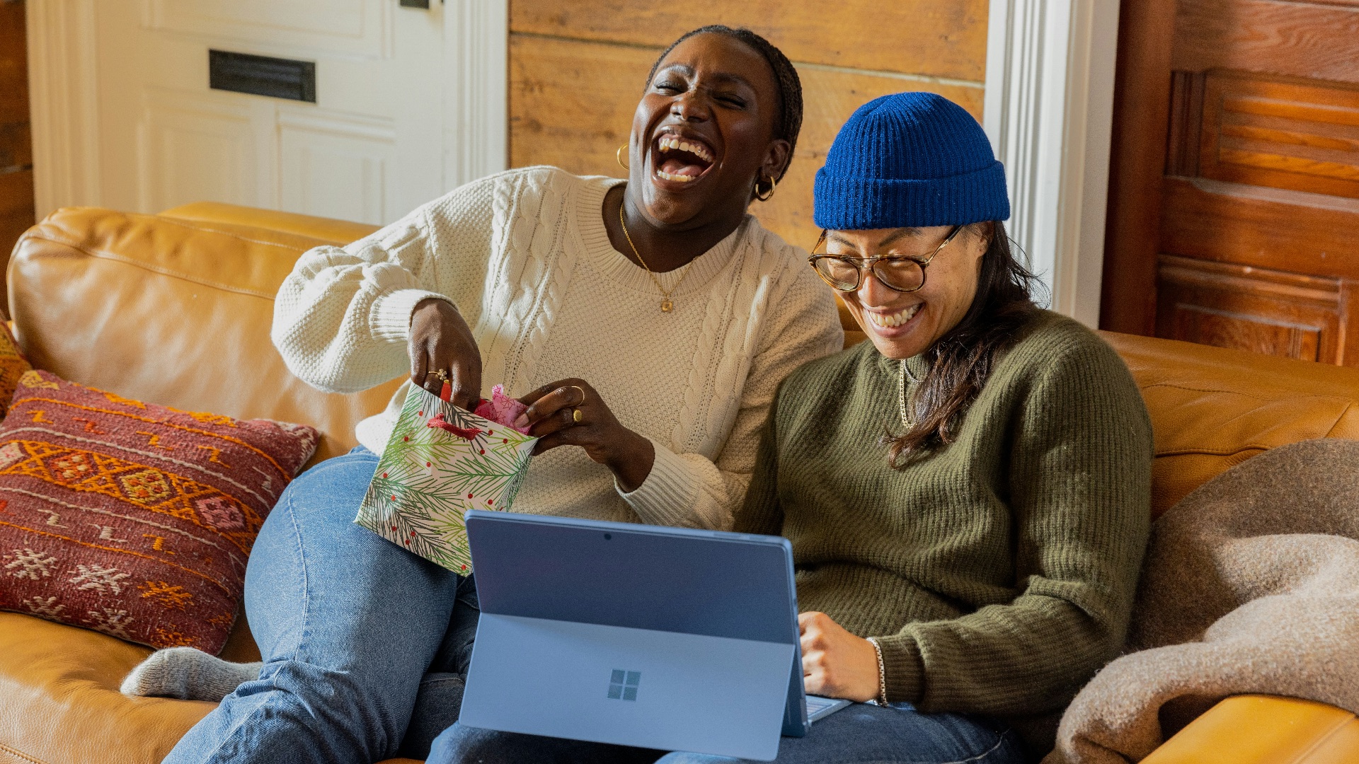 a person sitting on a couch with a laptop