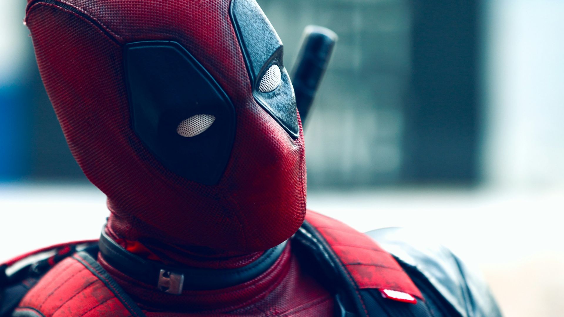 a man in a deadpool costume with a knife in his hand