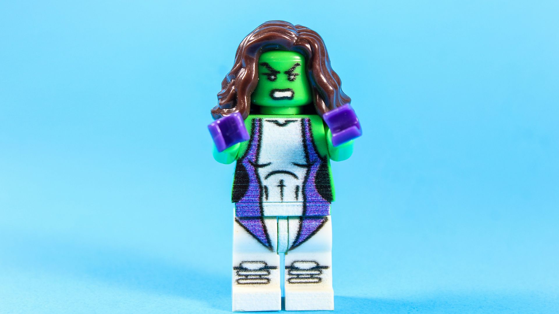 Lego she-hulk character with brown hair and purple fists