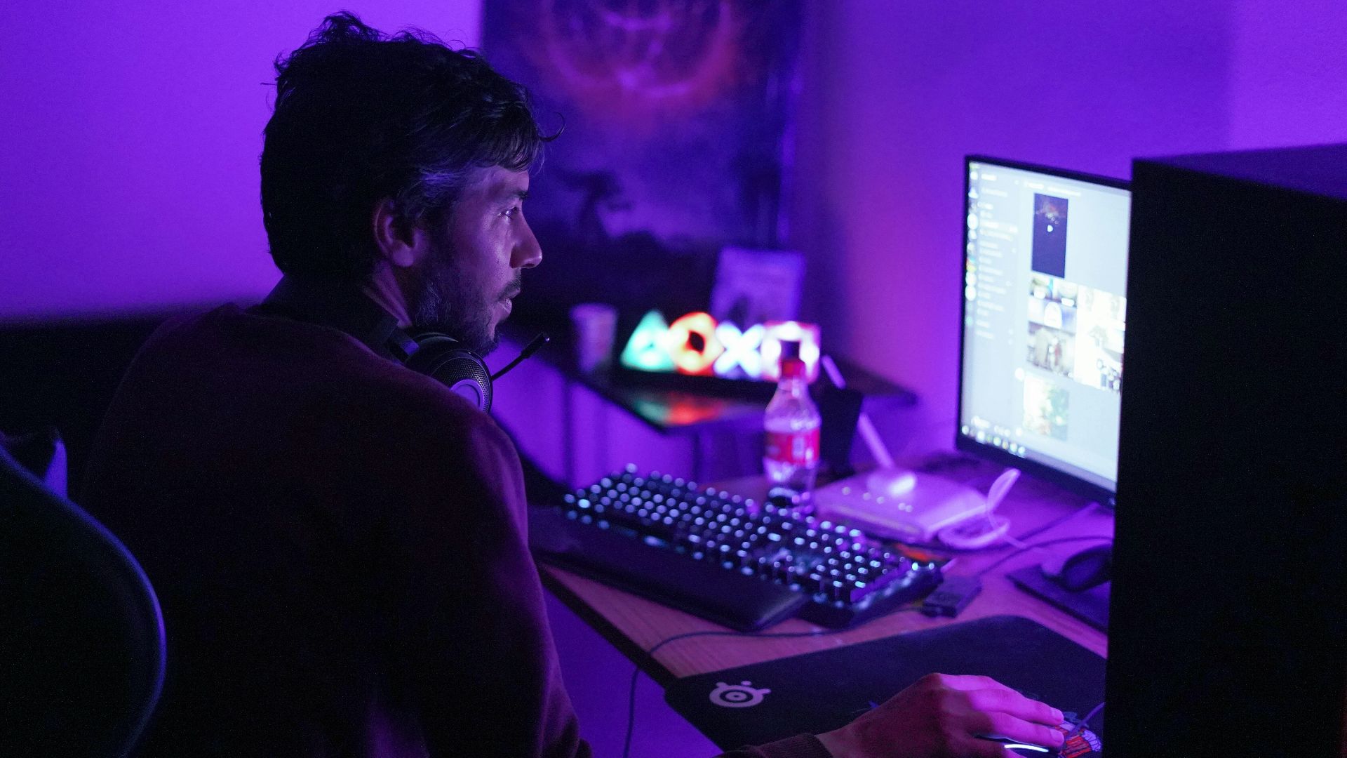 a man sitting in front of a computer monitor