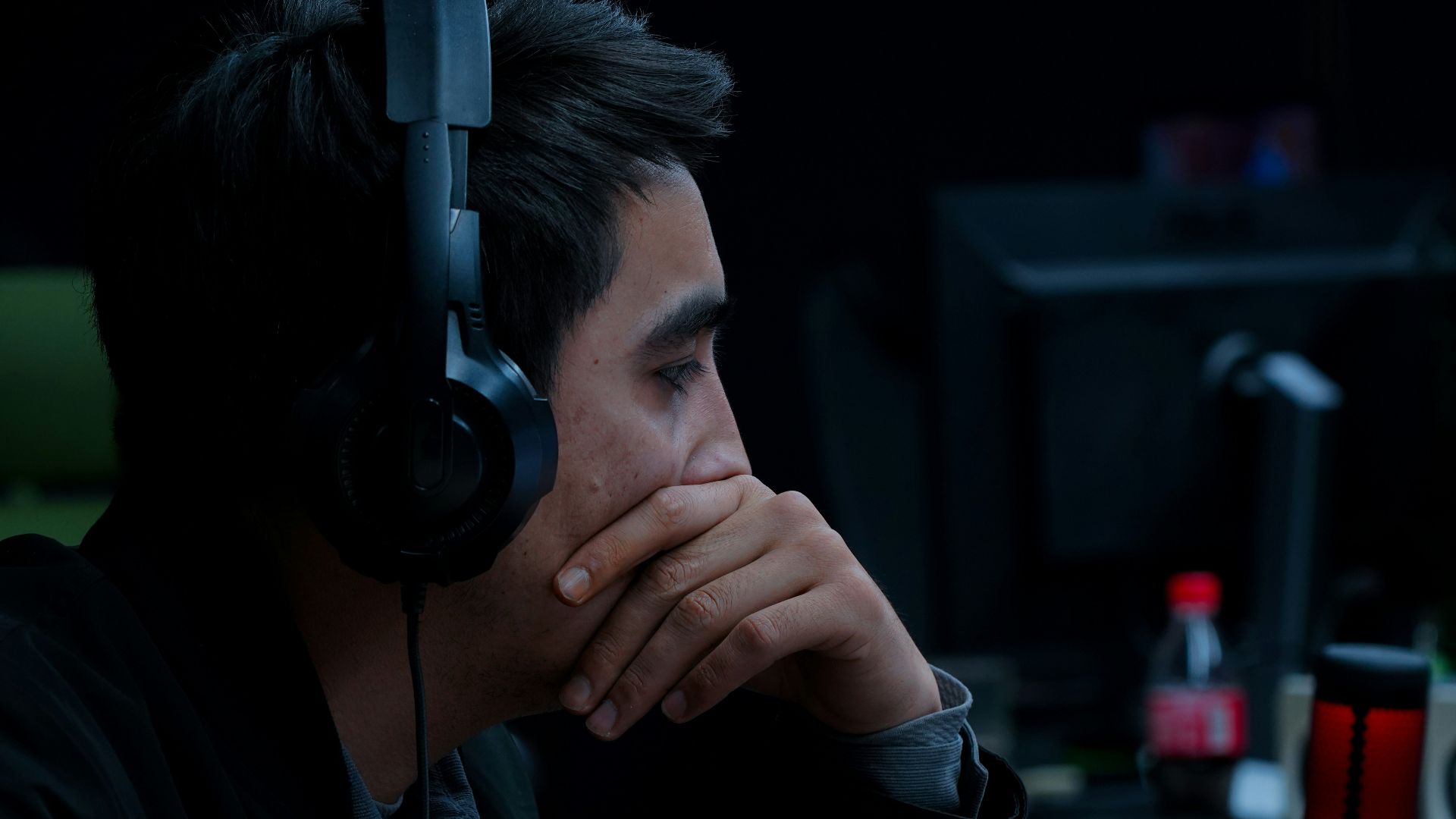 a man wearing headphones sitting in front of a computer