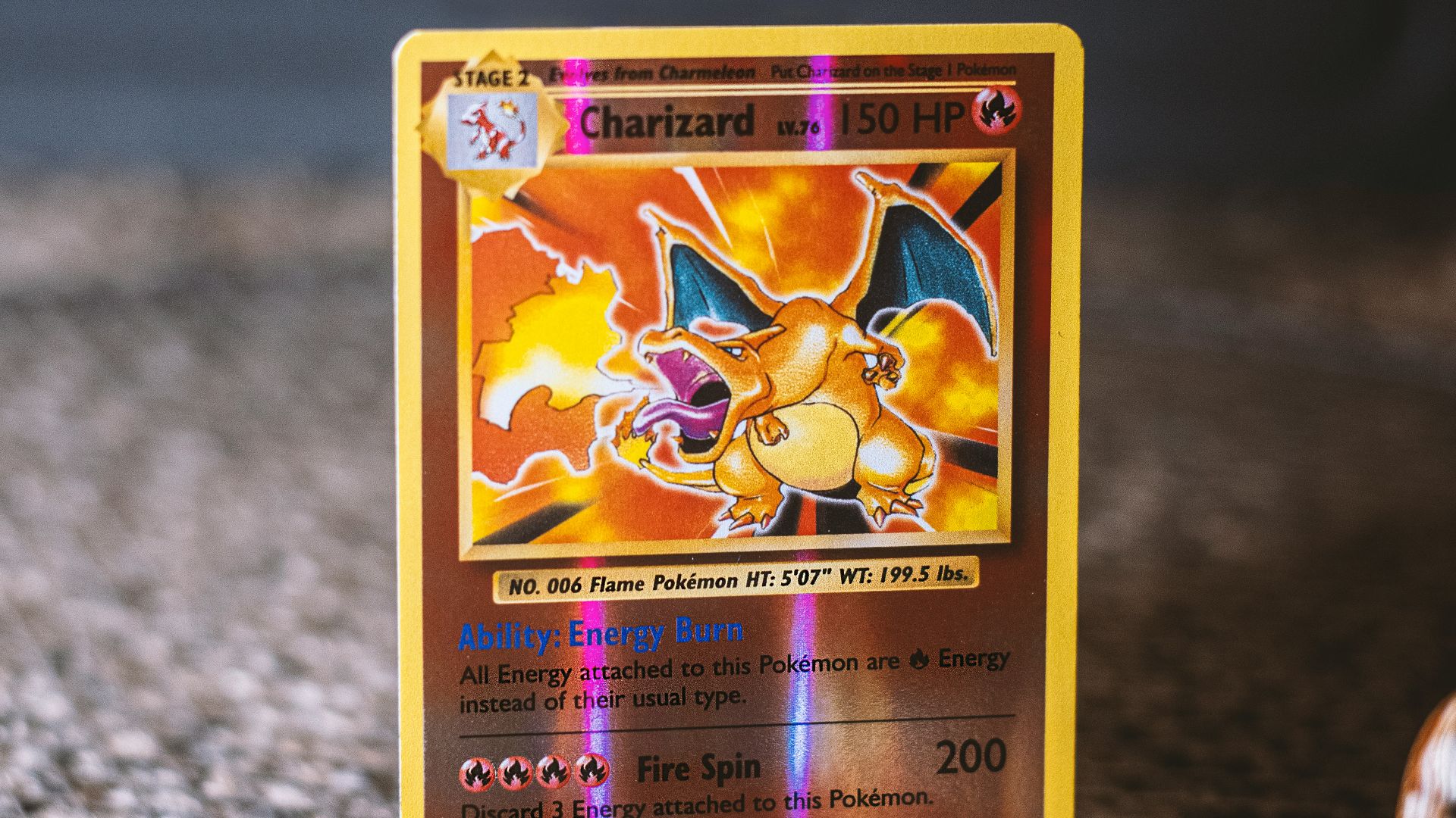 pokemon trading card on gray textile