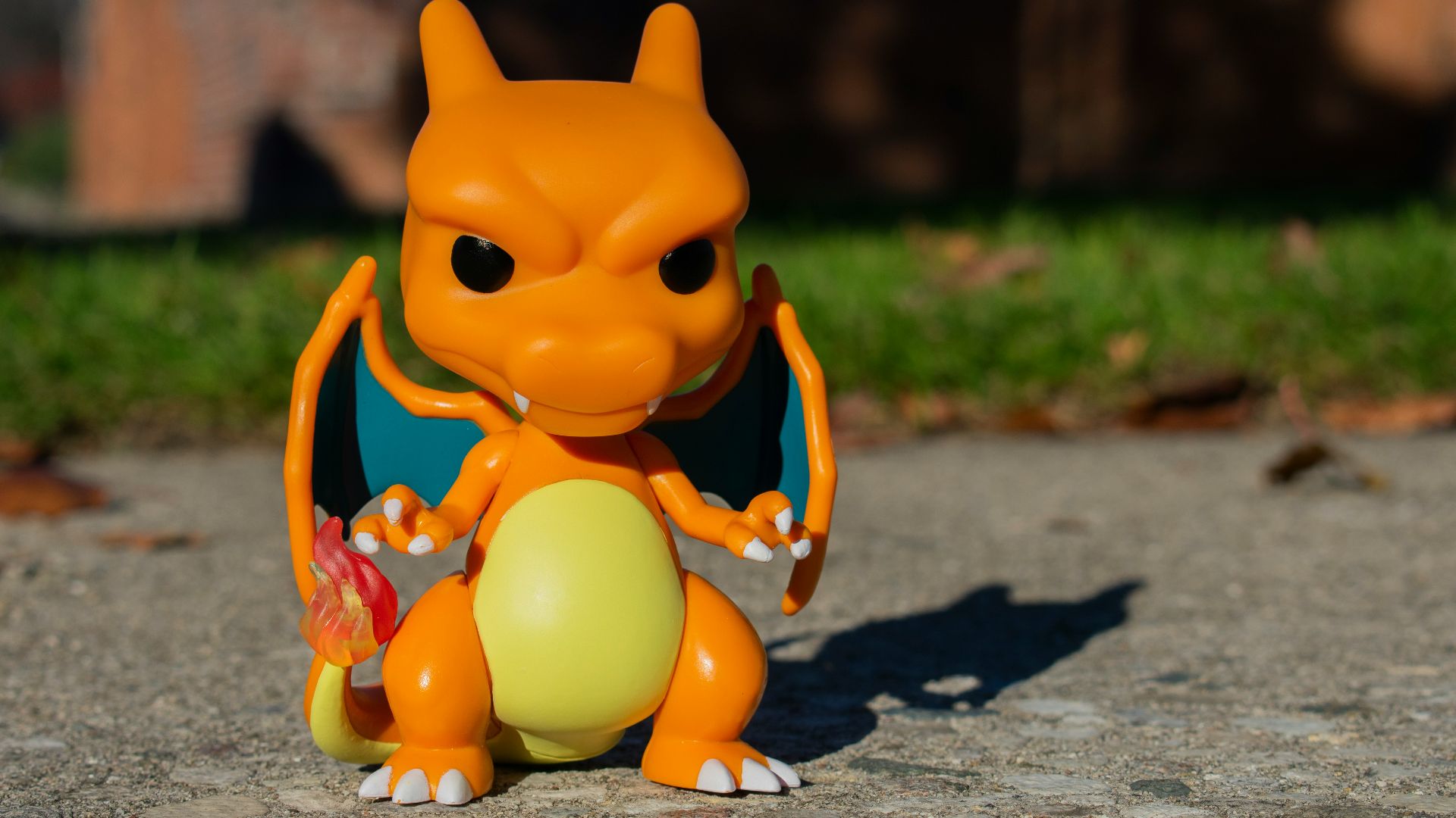 an orange toy sitting on top of a cement ground