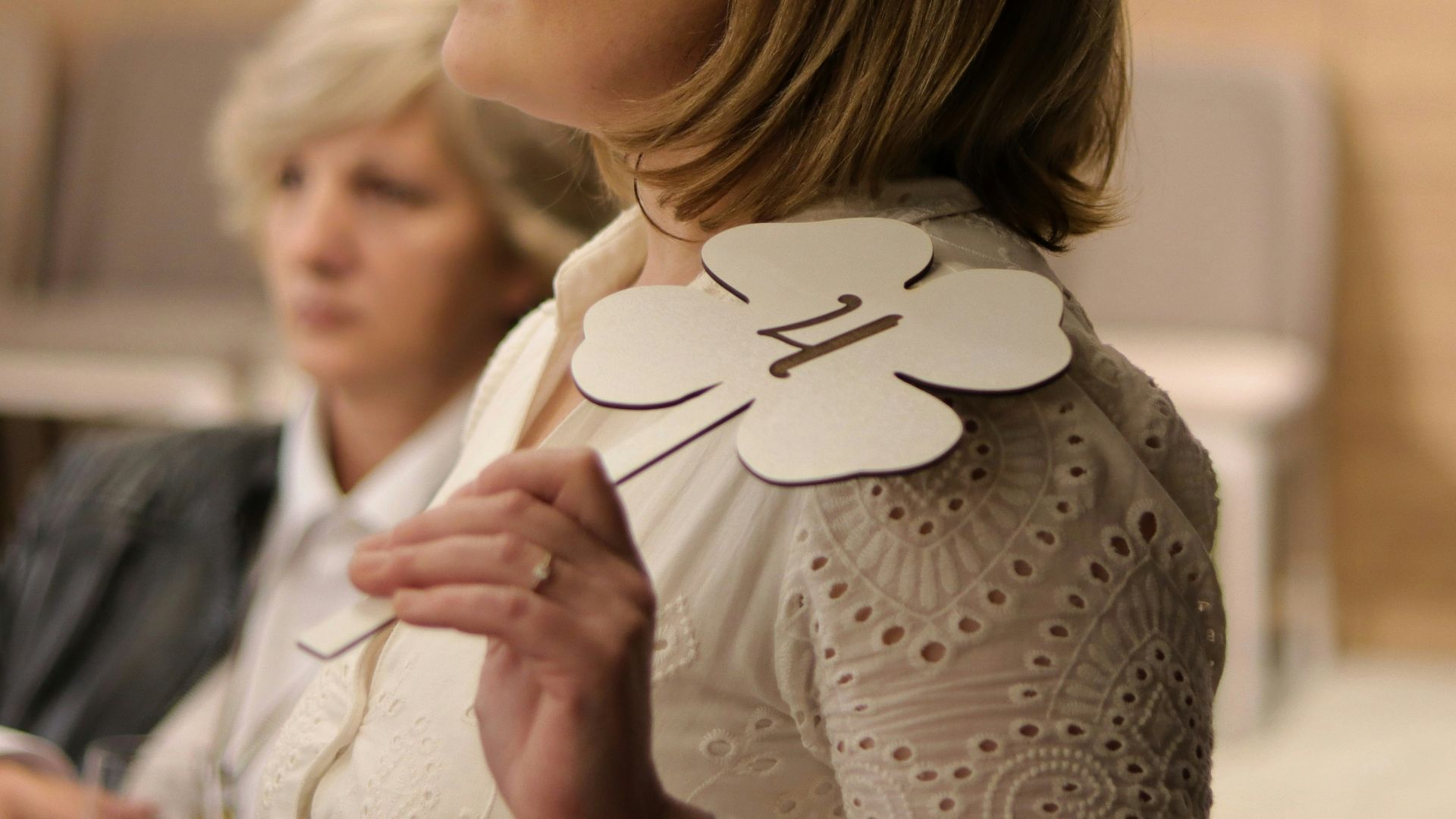 a woman standing next to another woman in a room