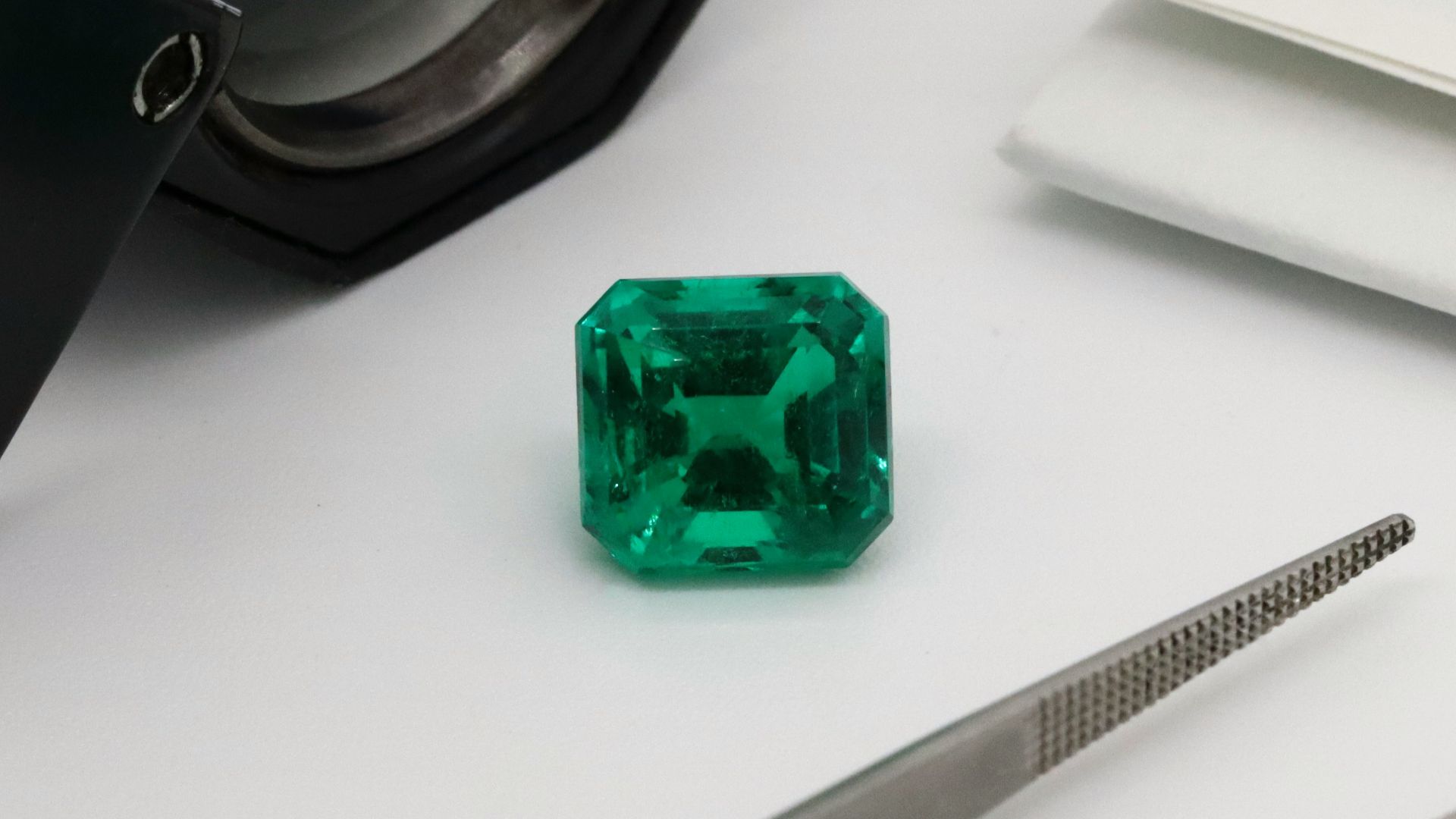 green glass bottle on white table