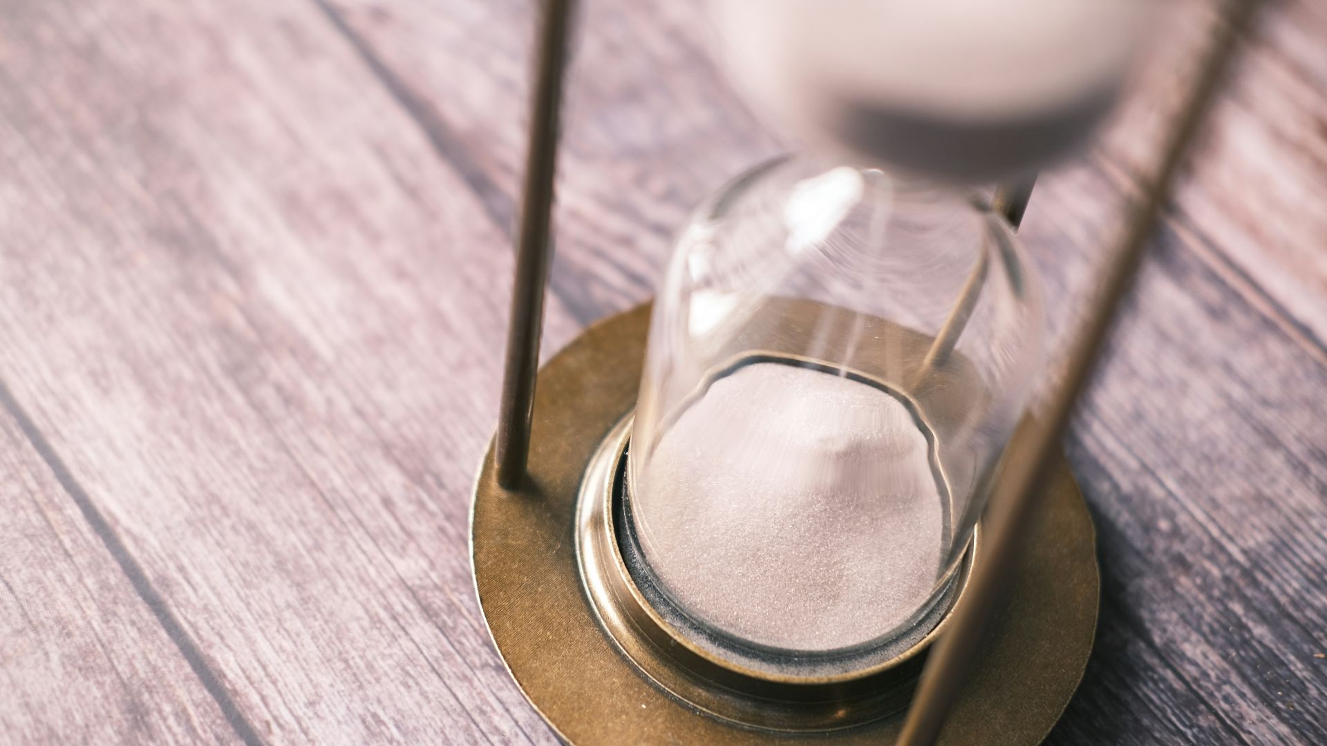 an hourglass sitting on top of a wooden table