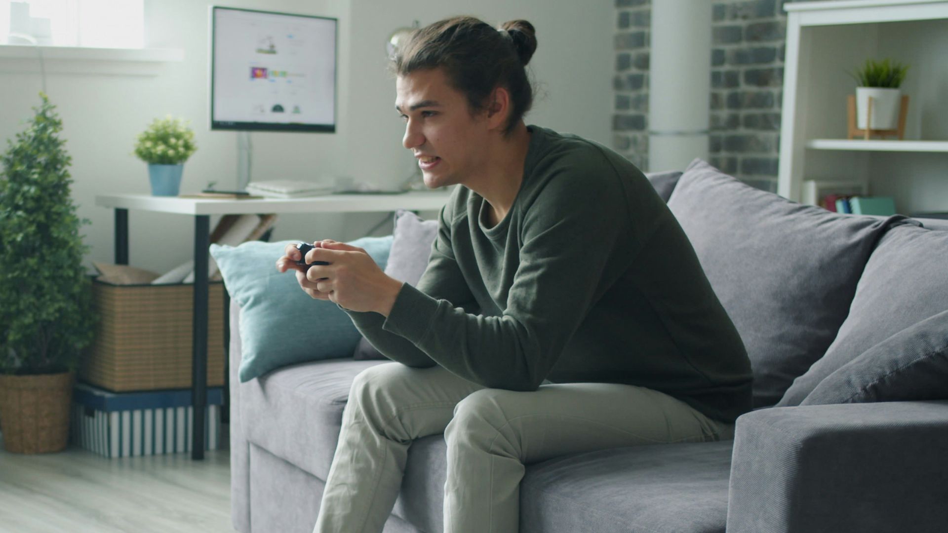 Man playing video games on couch