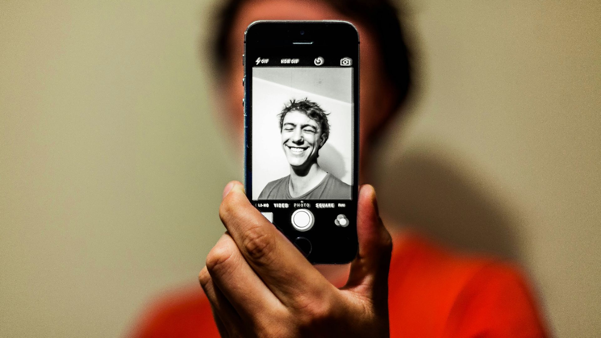 person holding space gray iPhone 5s taking picture