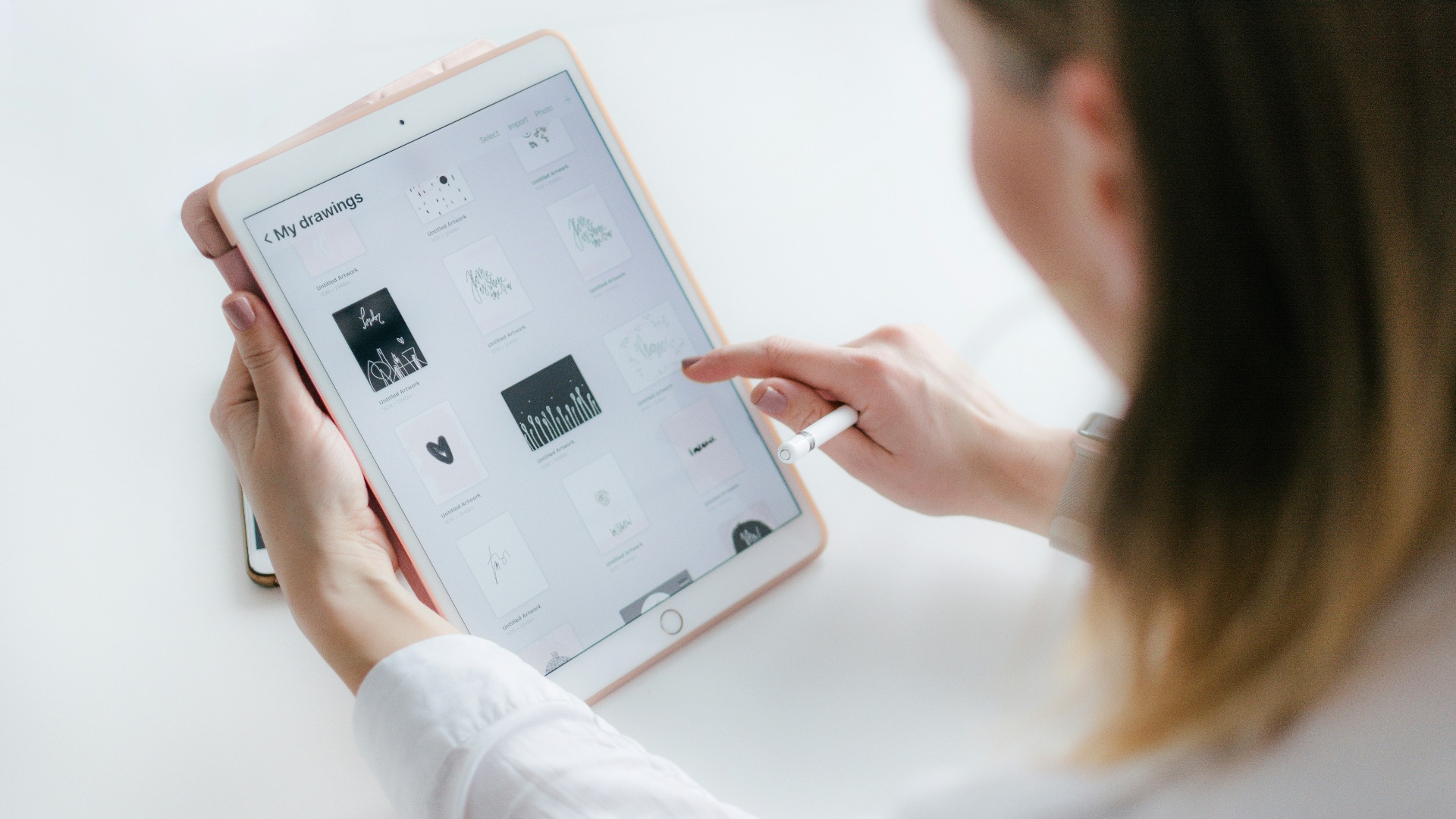 woman using gold iPad