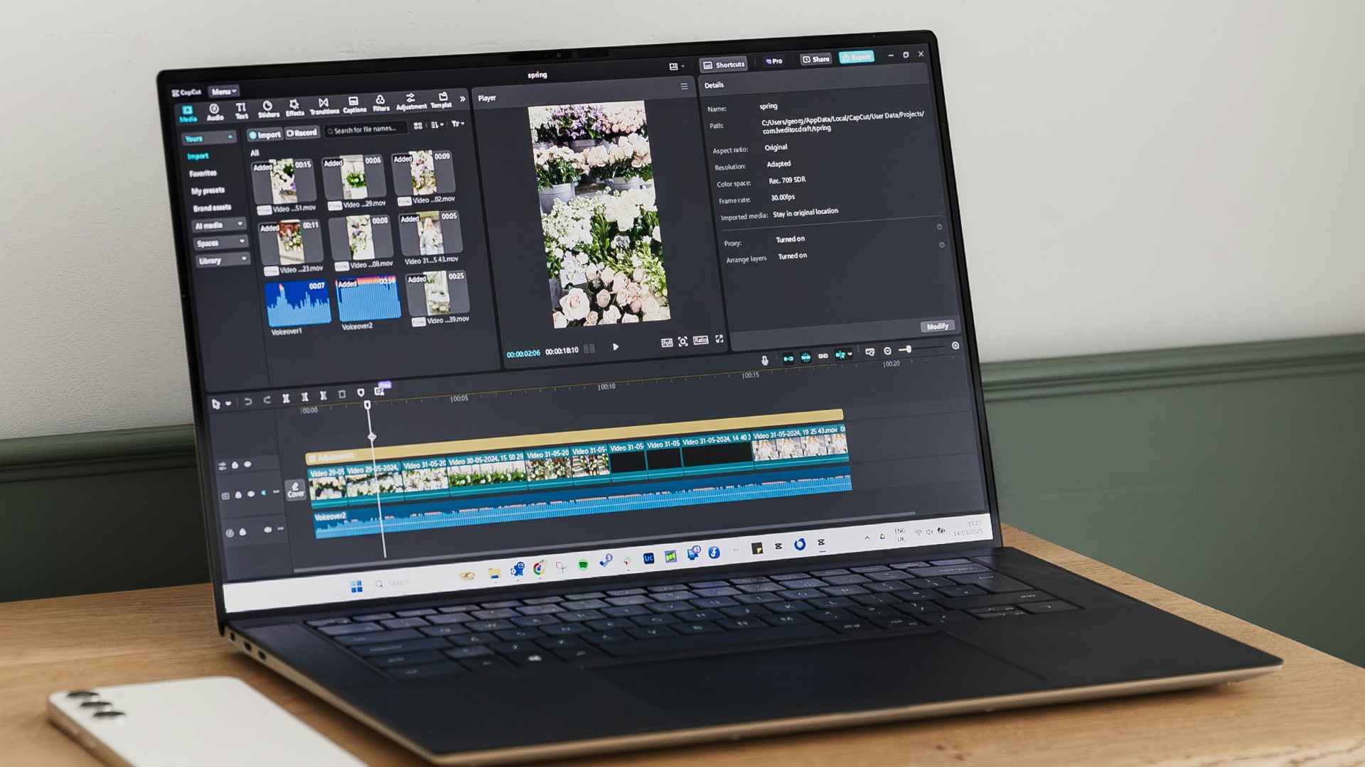 A laptop is displaying video editing software.