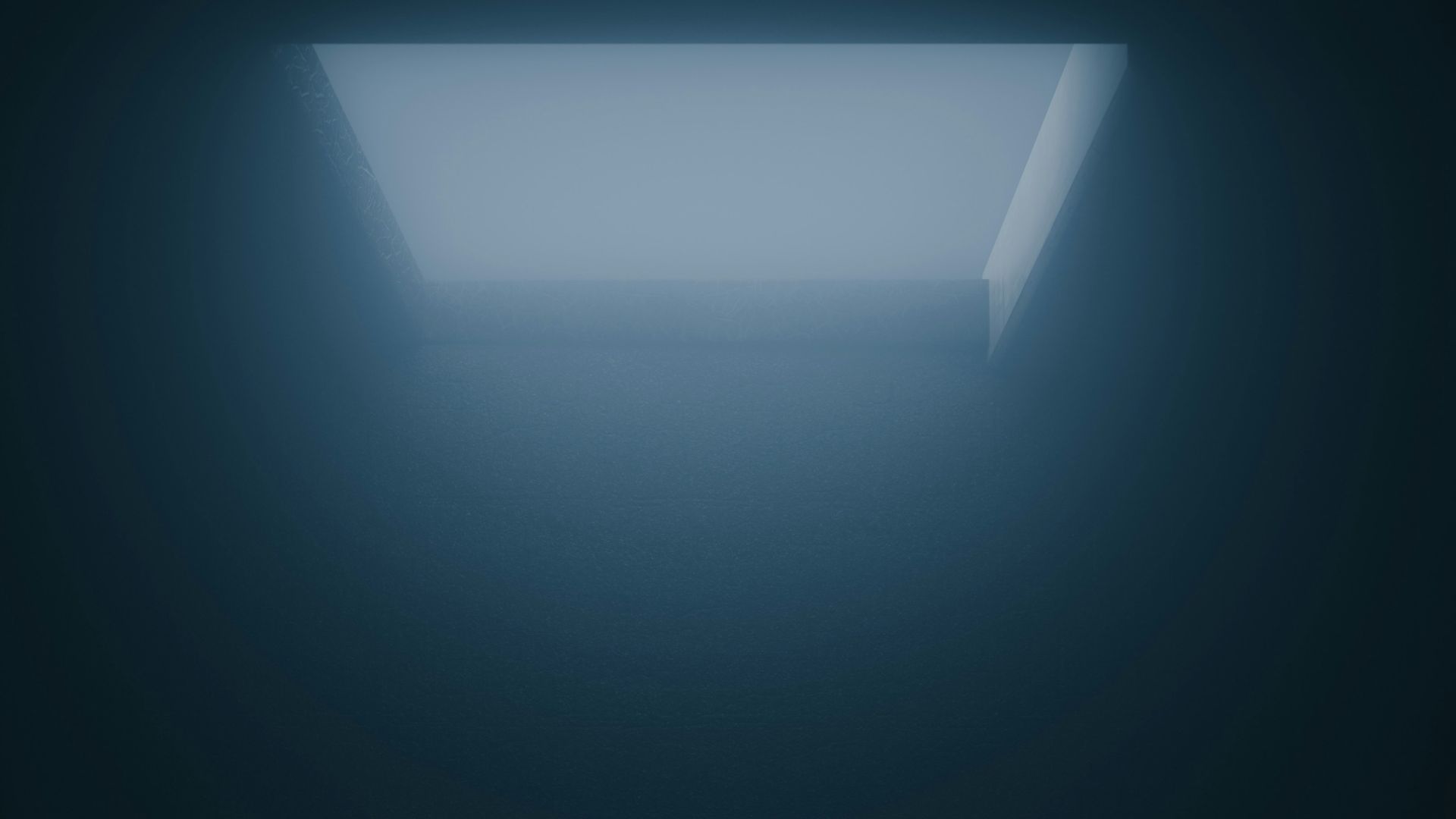 a dark room with a light coming from the ceiling