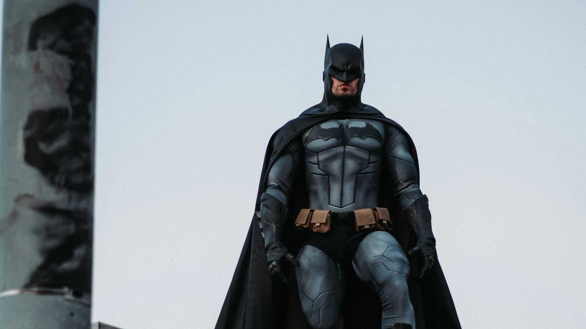 man in black jacket and pants standing on roof