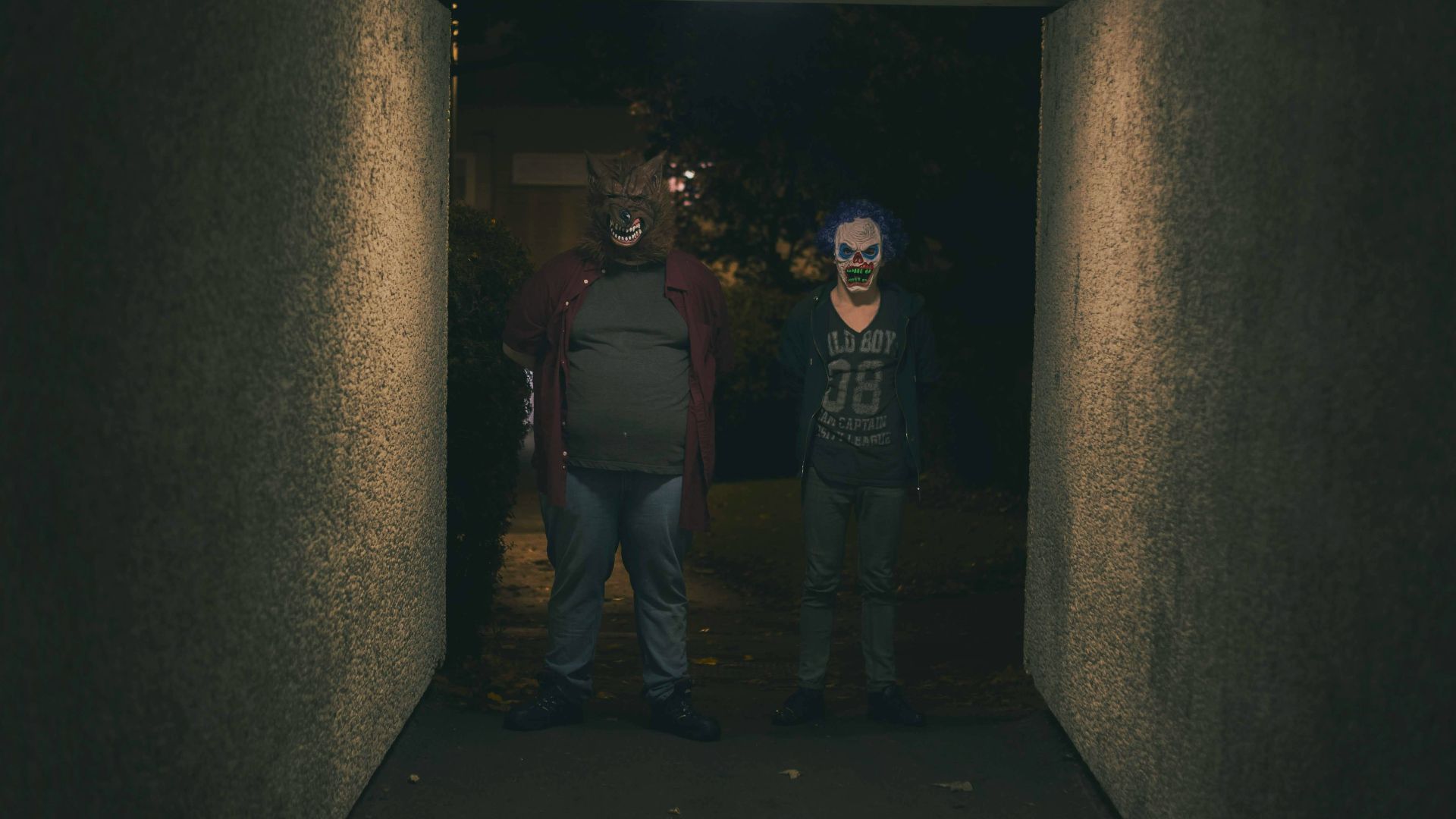 a couple of people that are standing in a hallway