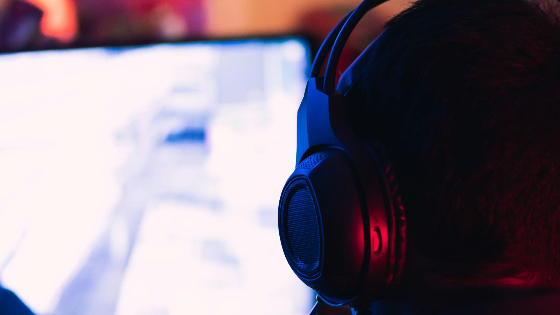 man in red shirt wearing black headphones