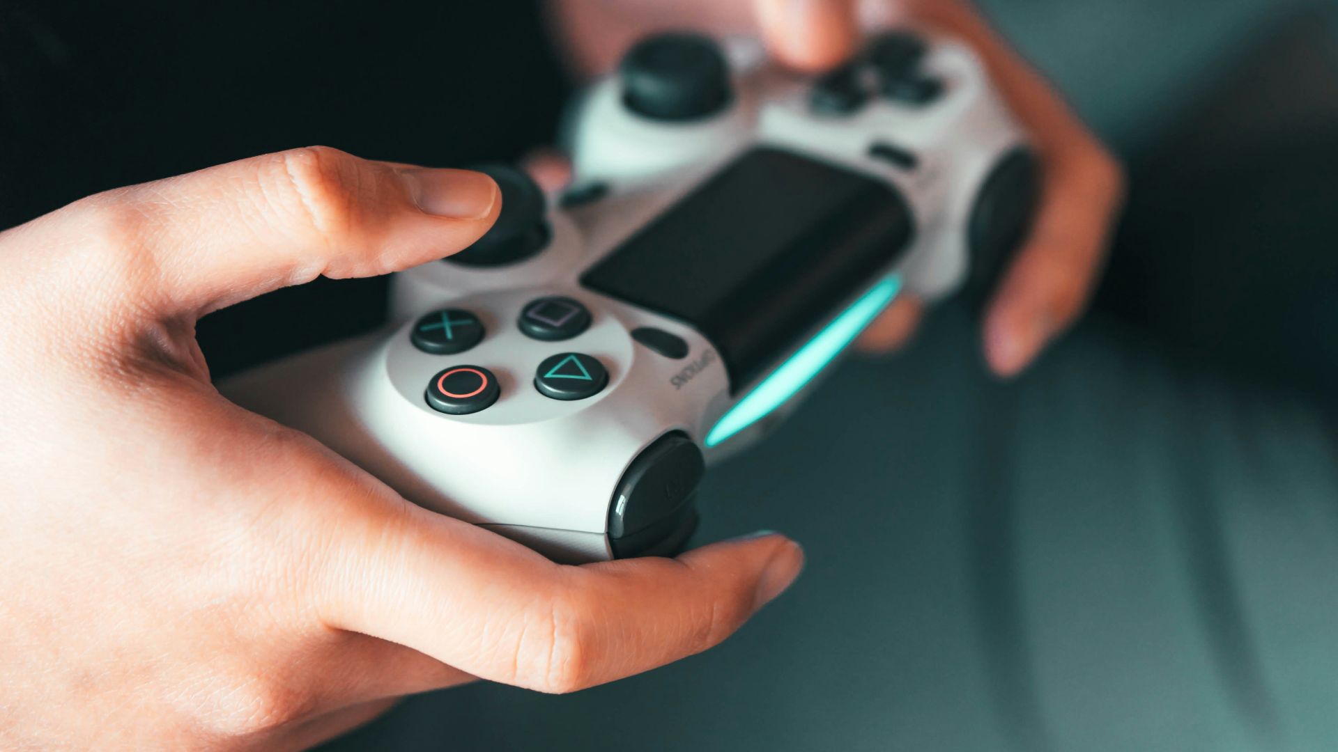 person holding gray game controller