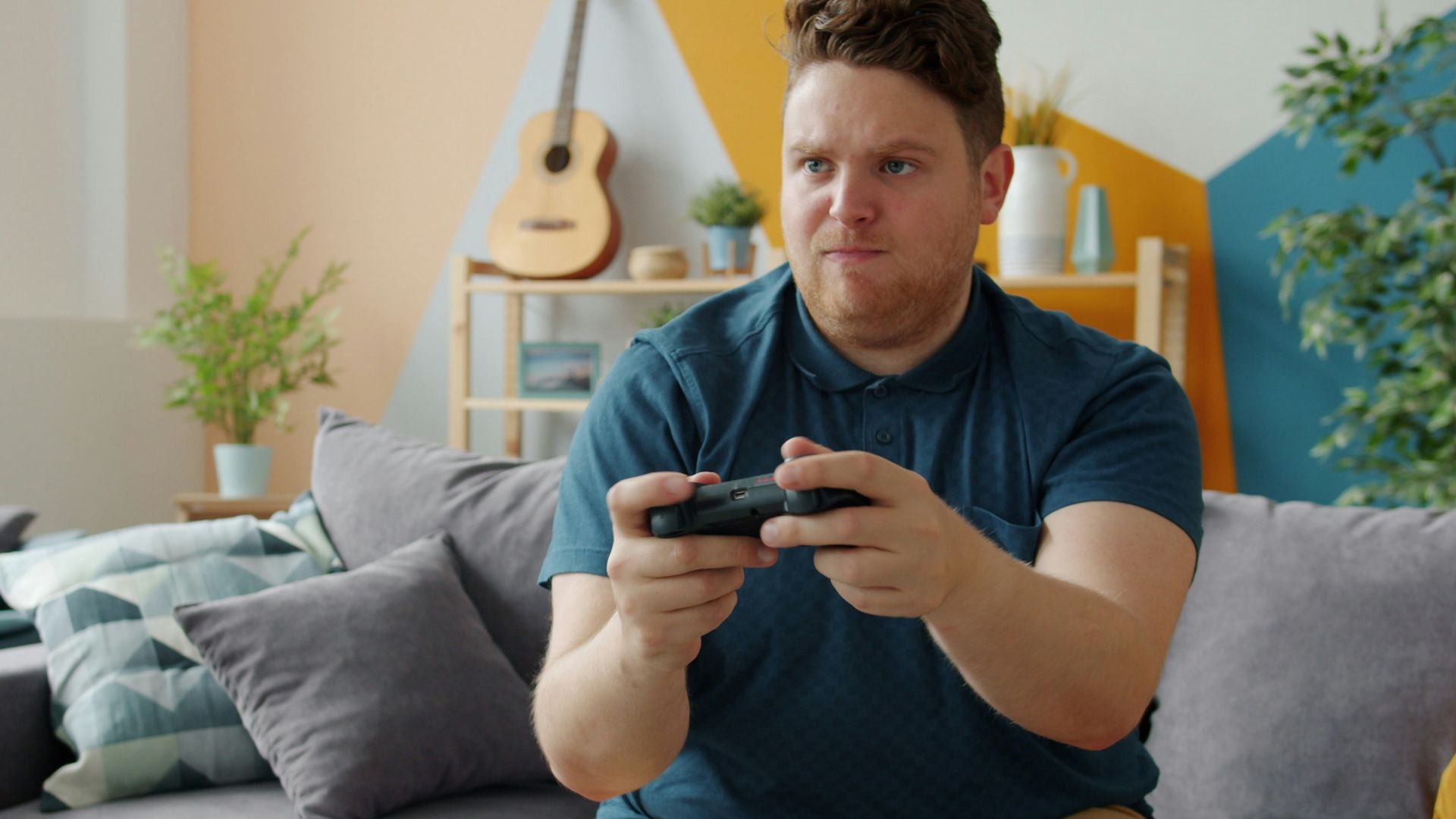 Man playing video games on a couch