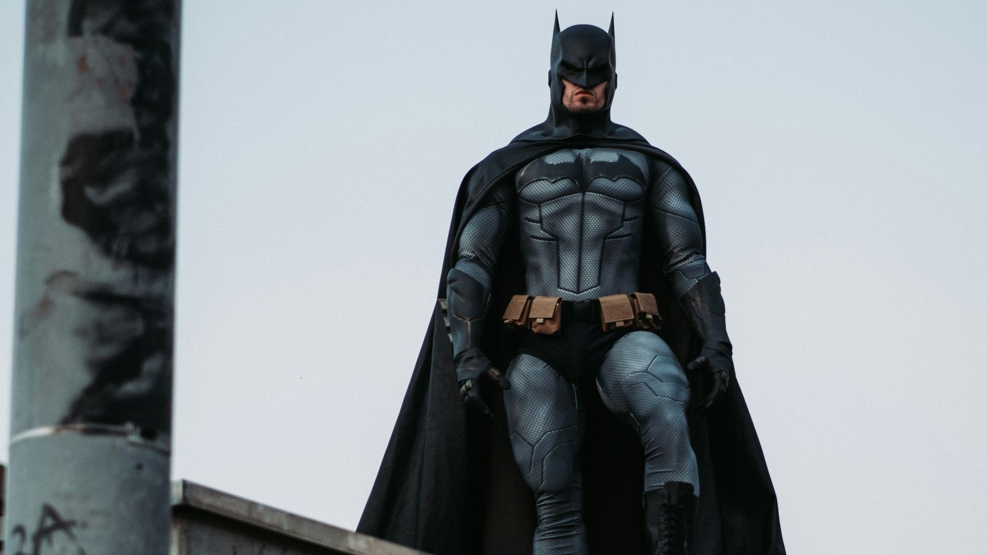man in black jacket and pants standing on roof