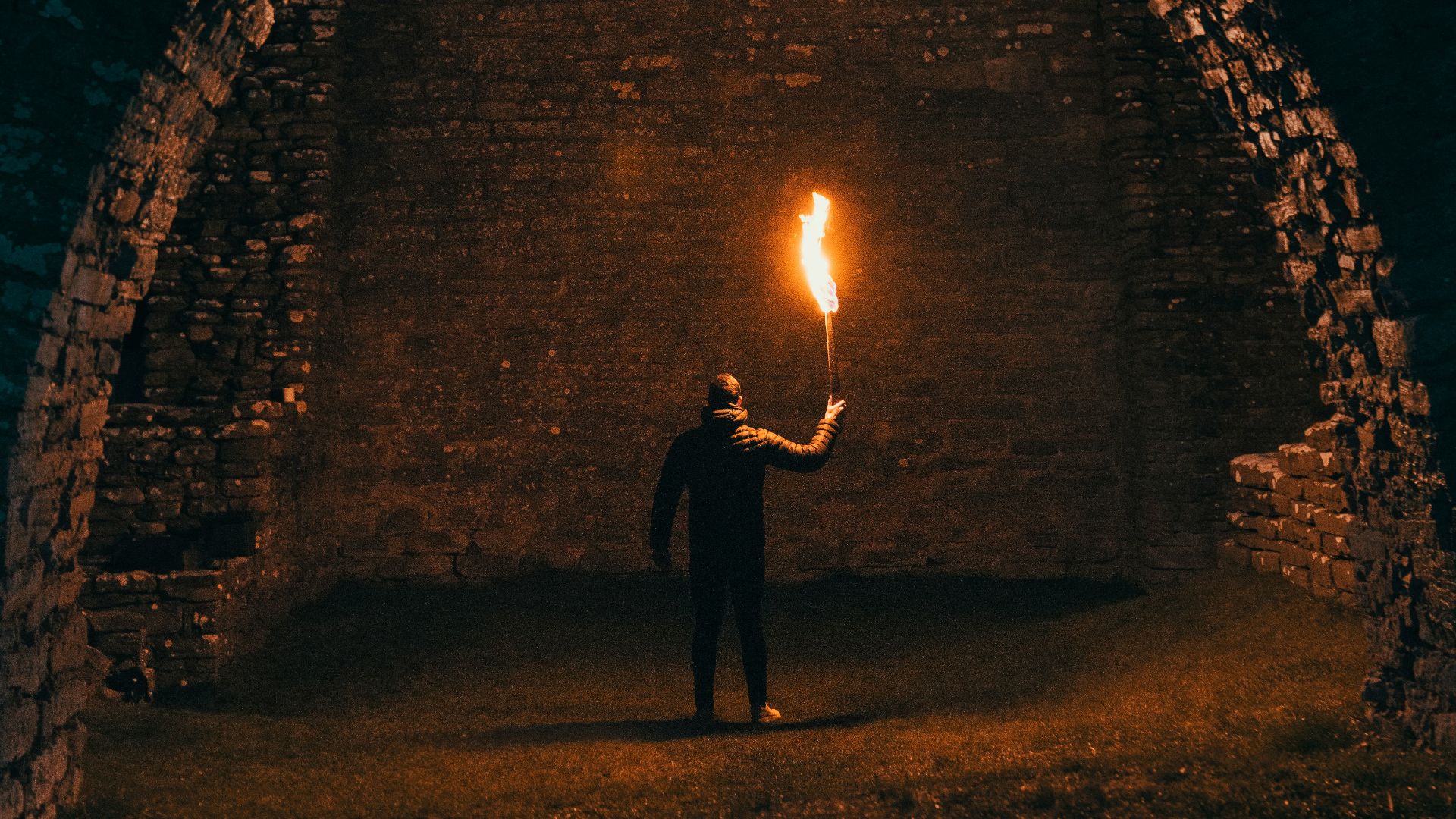 person holding torch in building interior