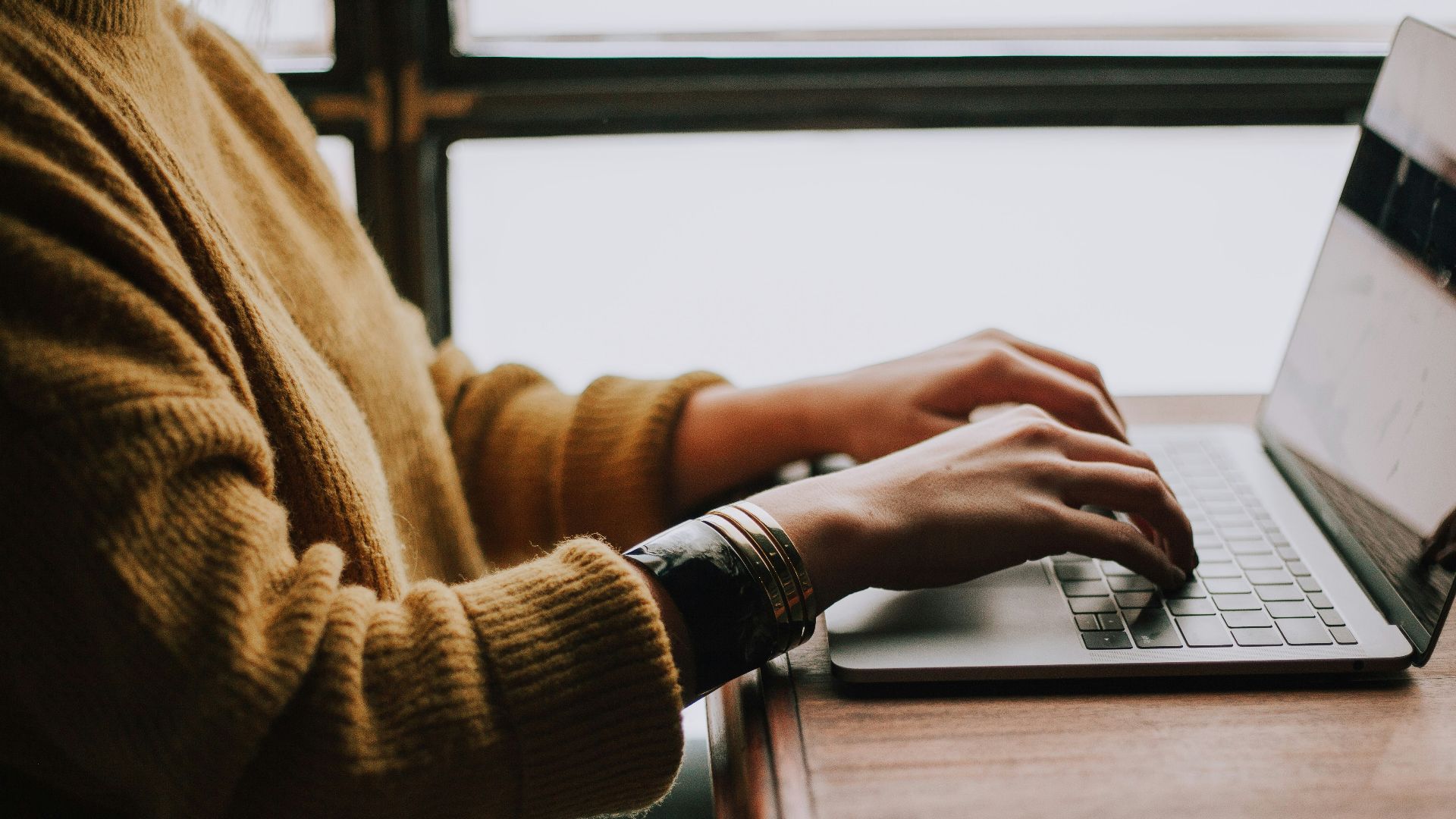 person sitting front of laptop