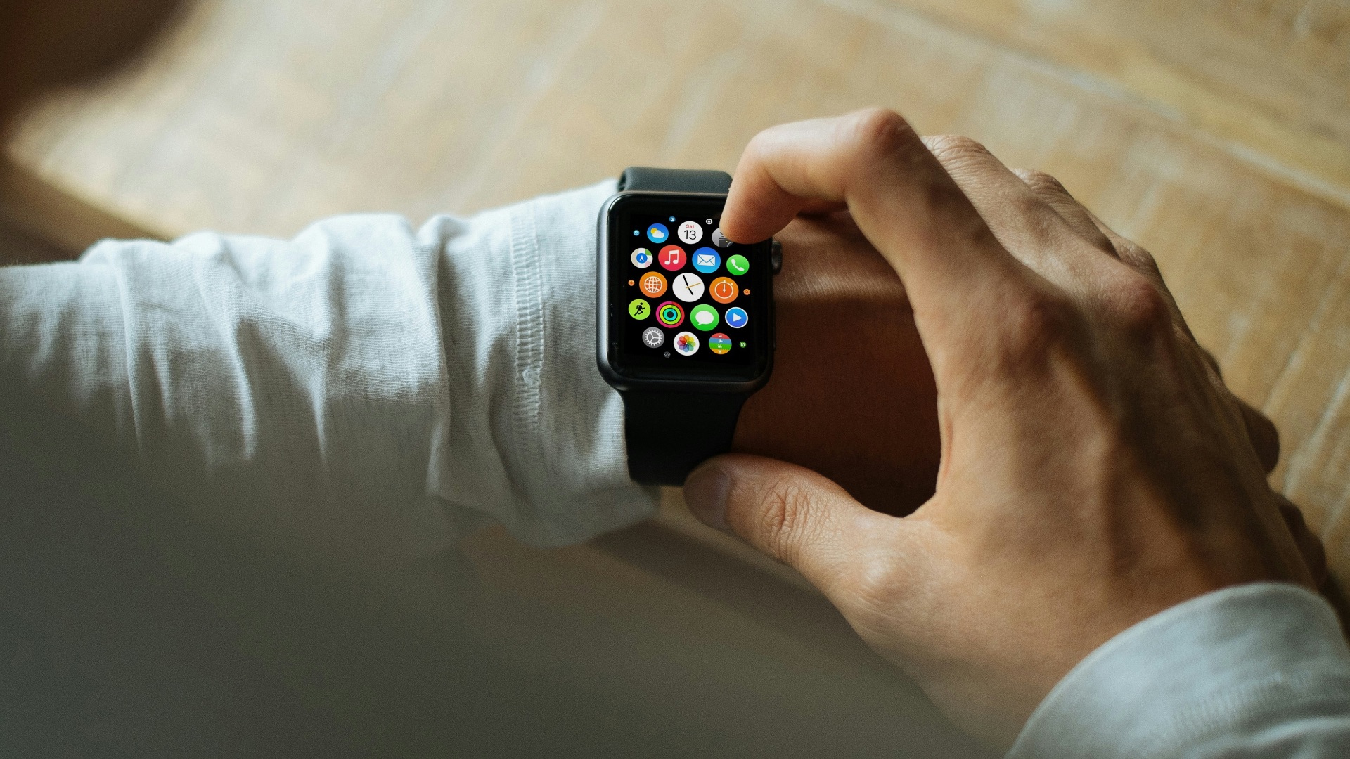 person holding Apple Watch with black Sport Band