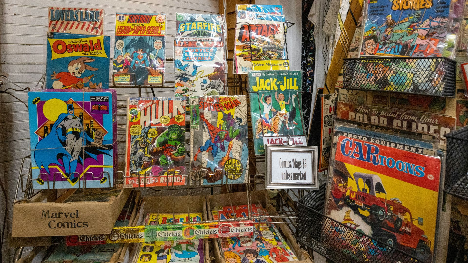 a bunch of comics are on display in a store