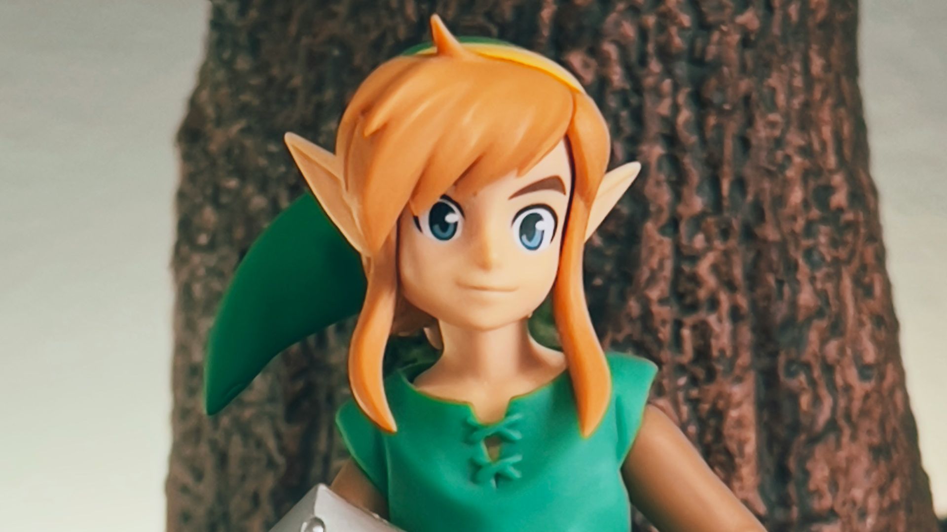 a toy girl holding a sign