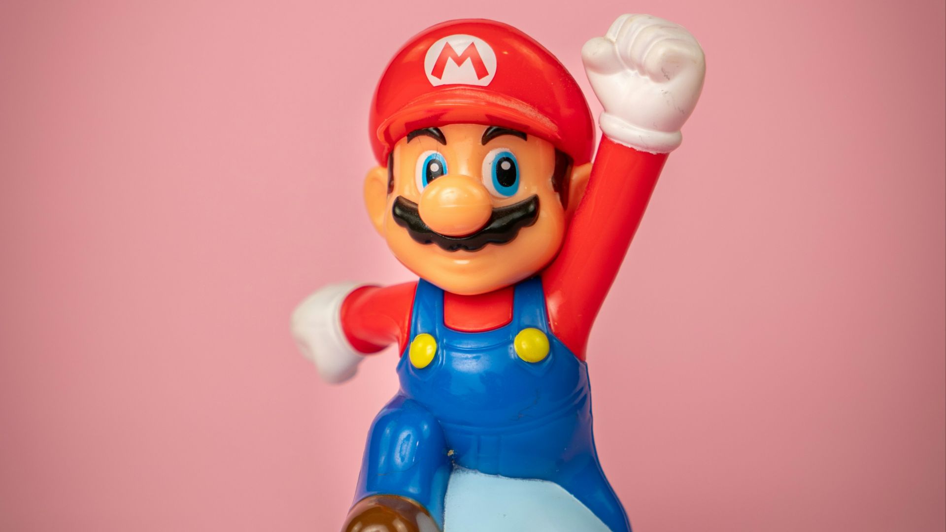 a toy figure of mario on top of a blue object