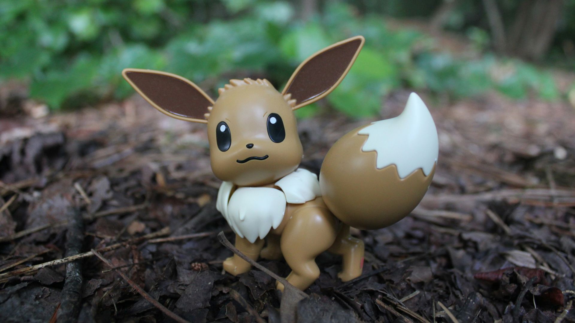 a small figurine of a pokemon sitting on the ground