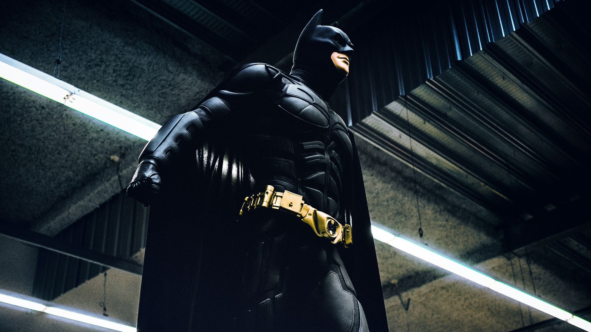 Batman standing under steel roof