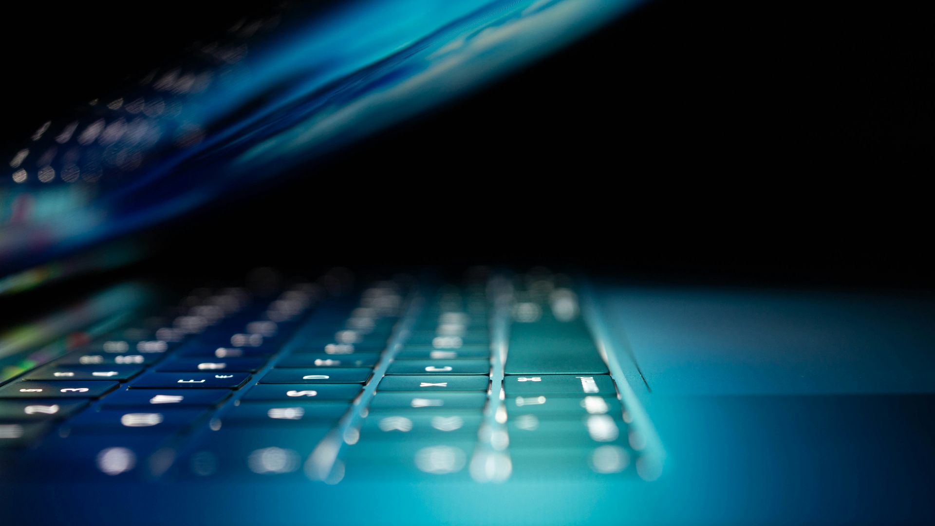 closeup photo of turned-on blue and white laptop computer