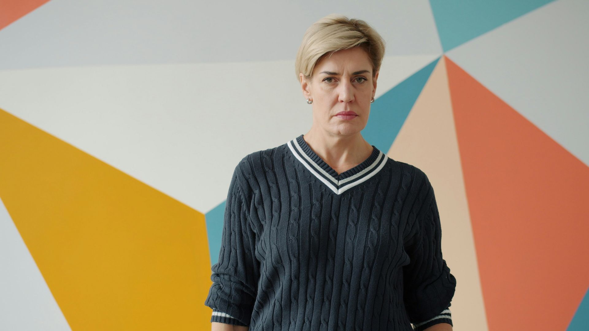 Woman with short blonde hair in a sweater