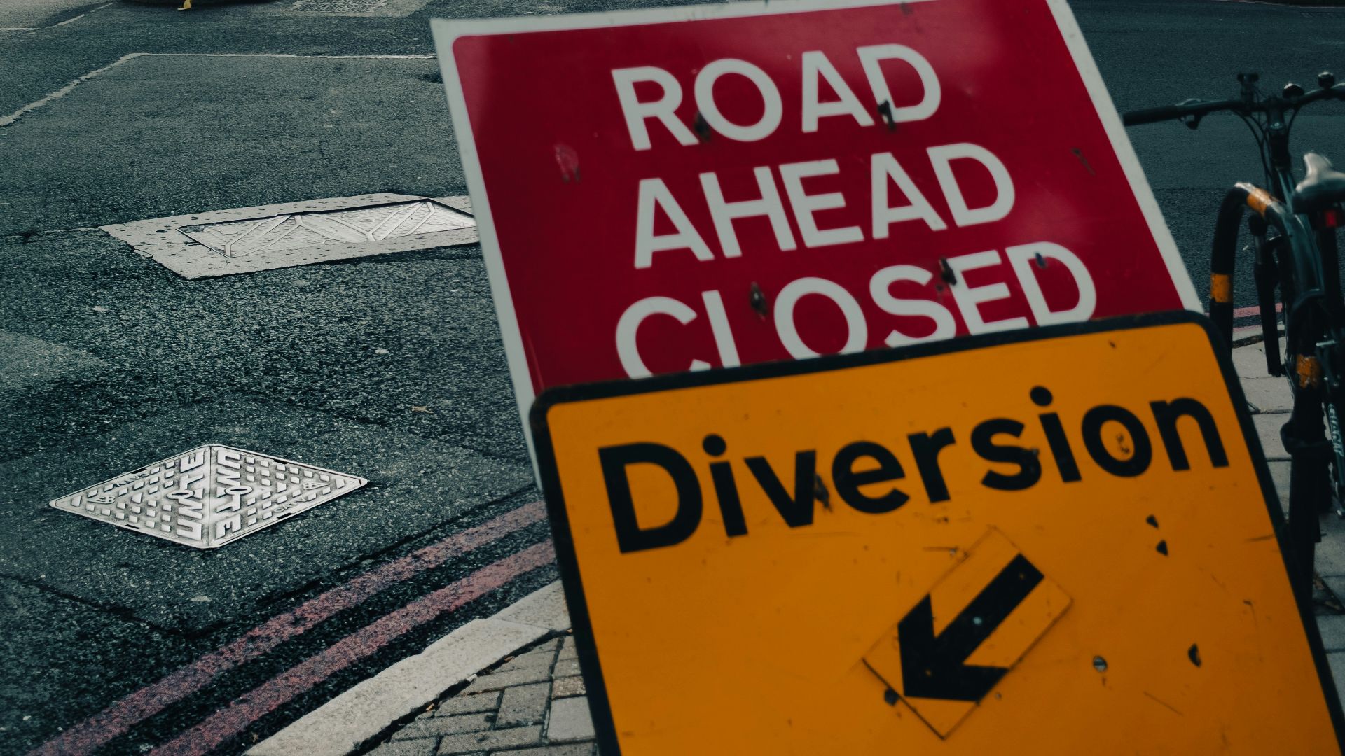 a road ahead closed sign on the side of the road