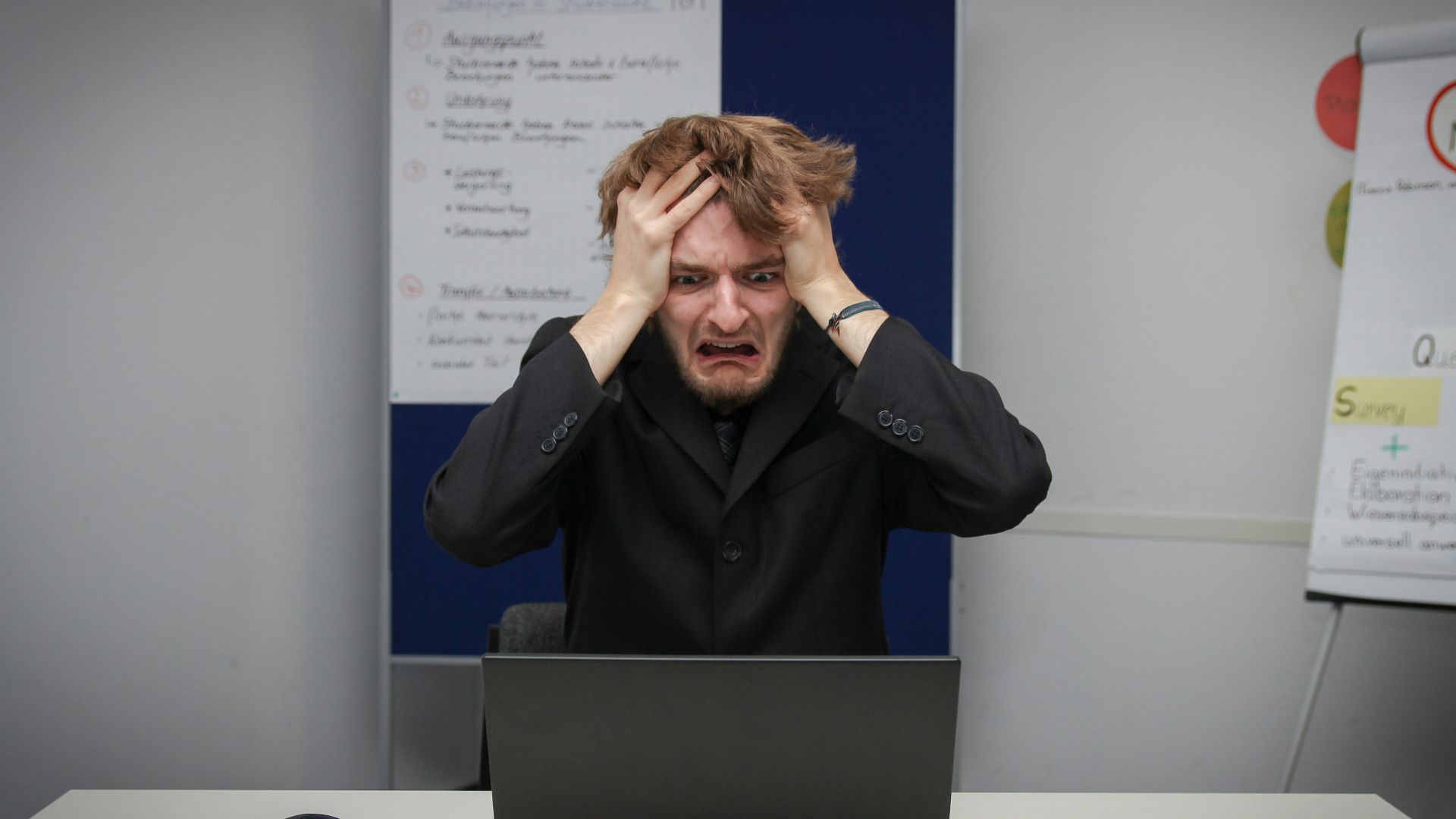 A man sitting in front of a laptop computer