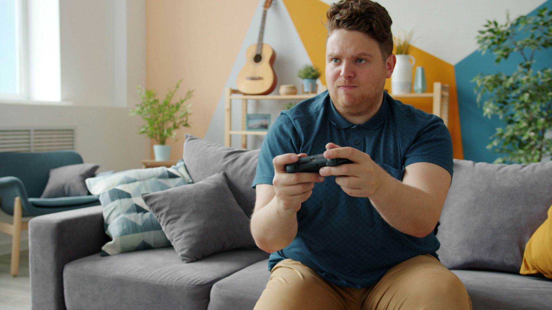 Man playing video games on a couch