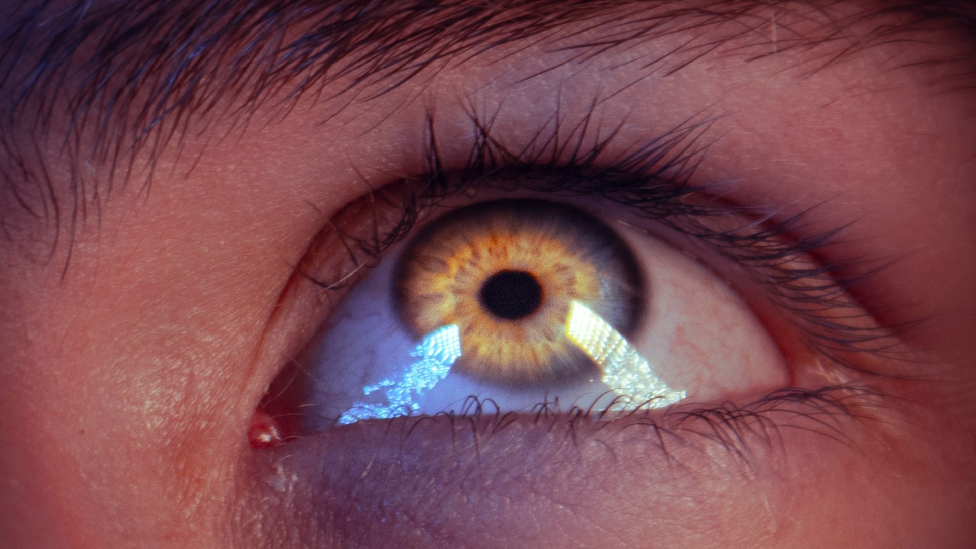a man's eye with the reflection of an eyeball in it