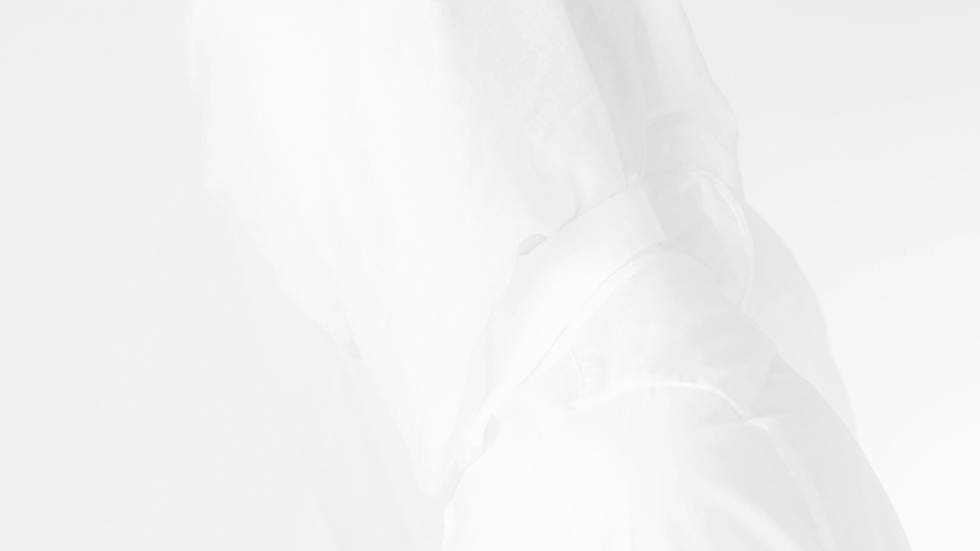 a person in a white jacket with a hood up