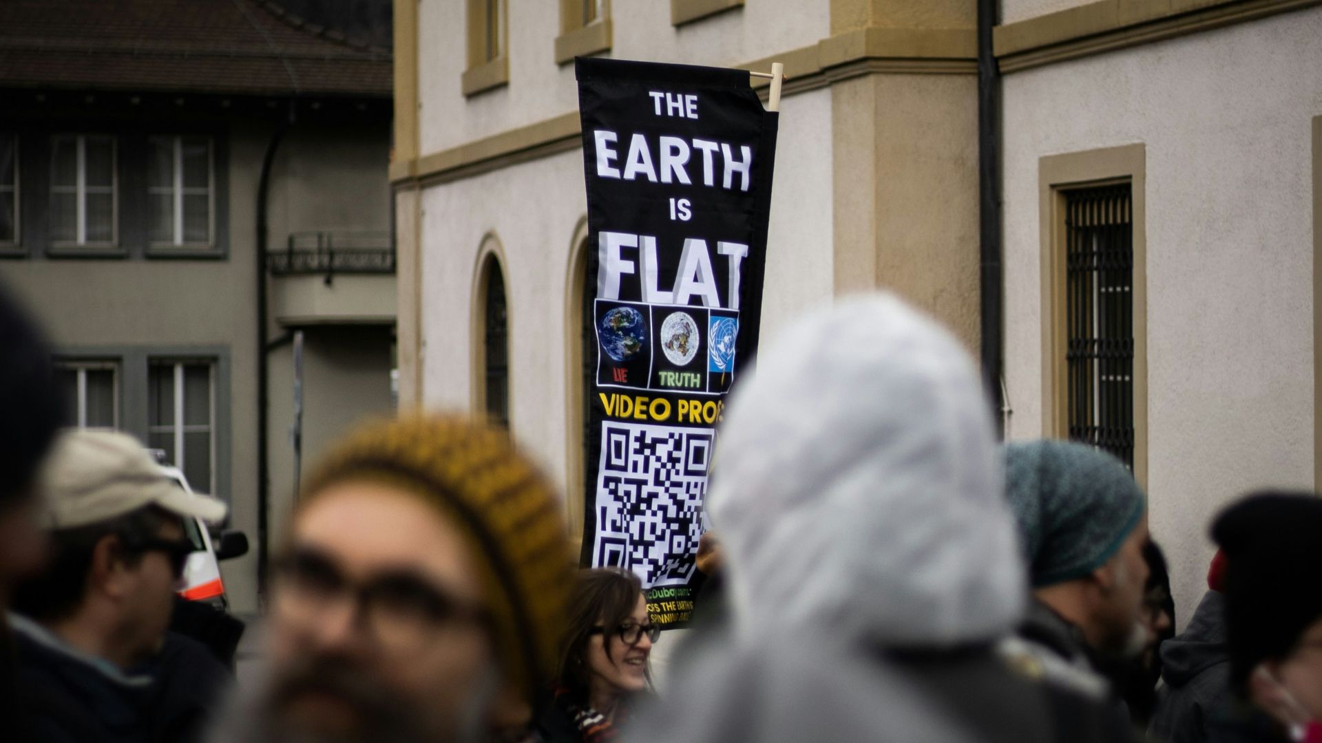 people in white and yellow hijab standing in front of building during daytime
