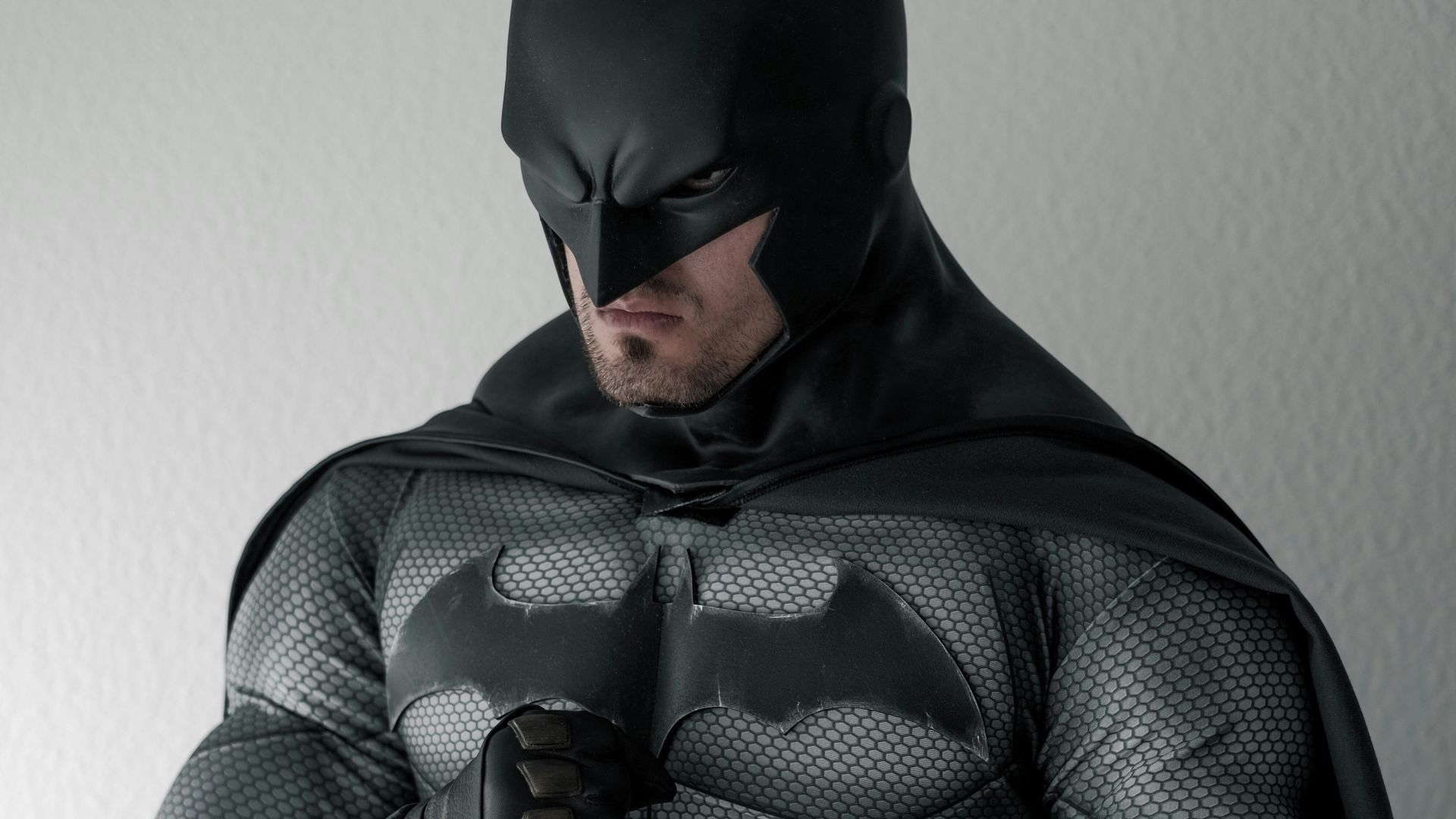 man in black and gray stripe hoodie sitting on brown wooden chair