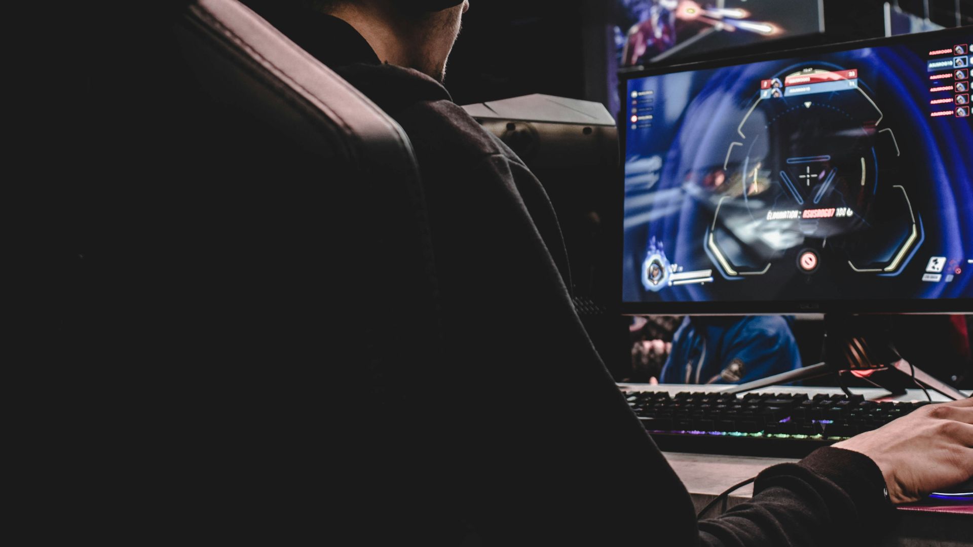 person sitting on gaming chair while playing video game