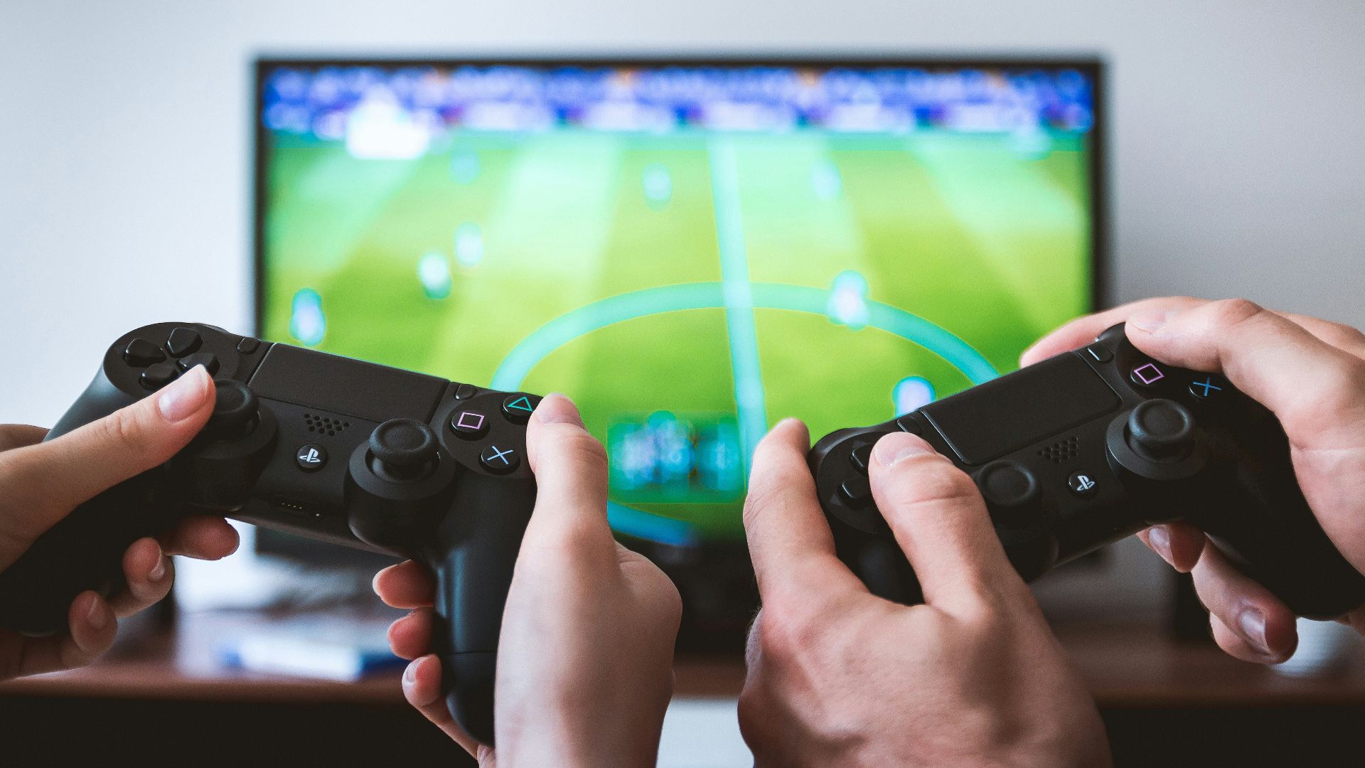 two people playing Sony PS4 game console