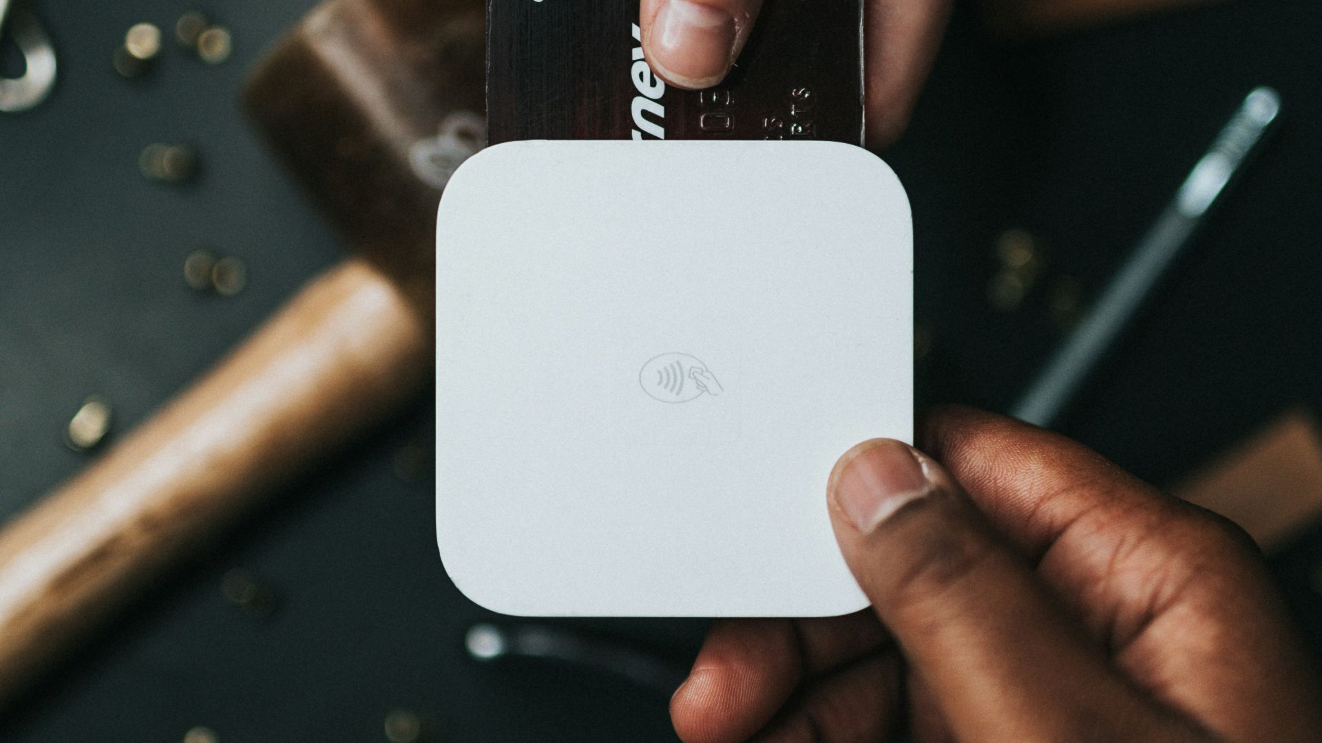 person holding Visa card and white device