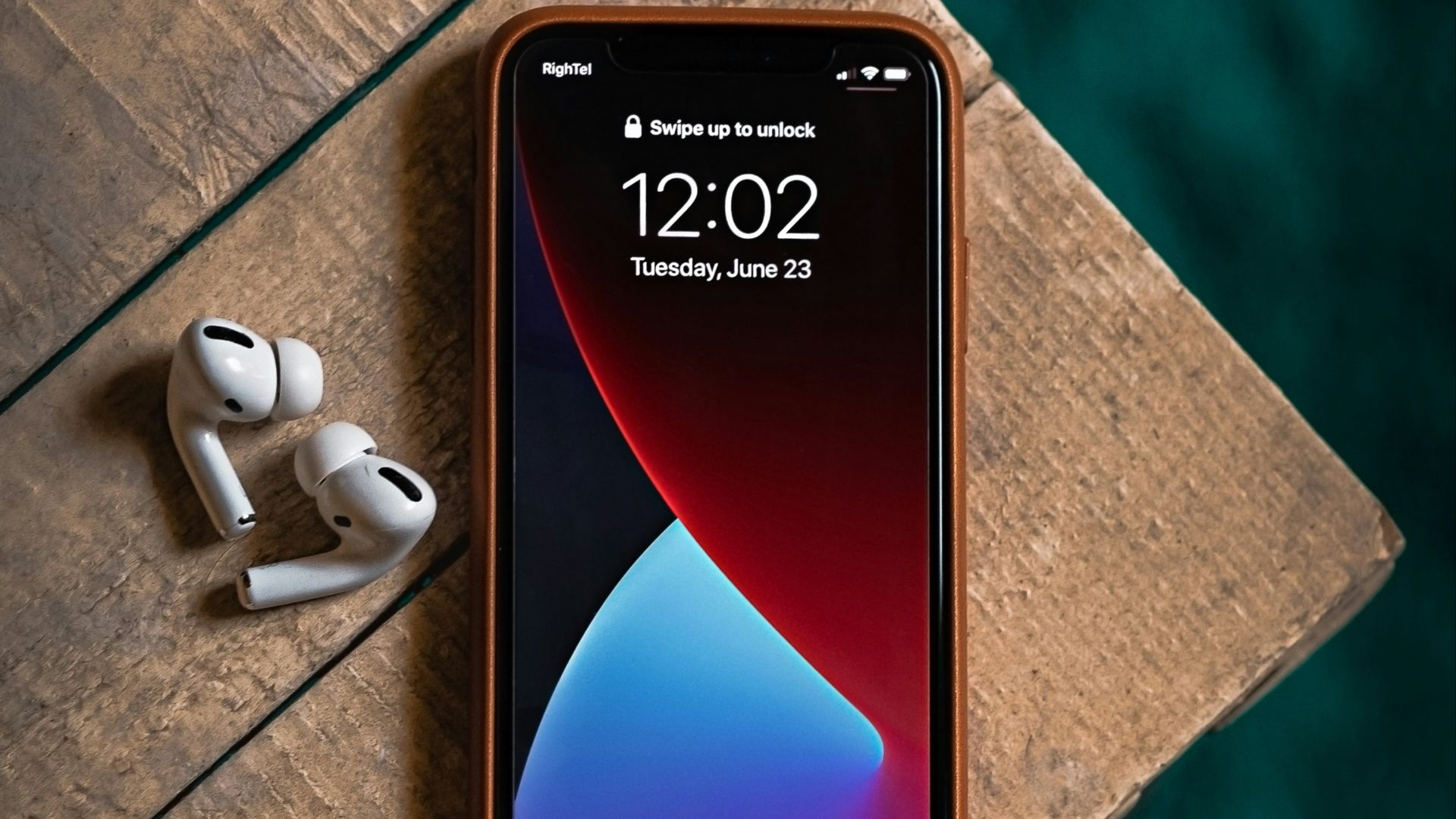 red and black samsung android smartphone beside white earbuds